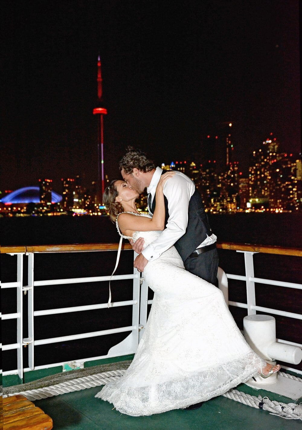 Couple Kissing on Boat with CN Tower in Background