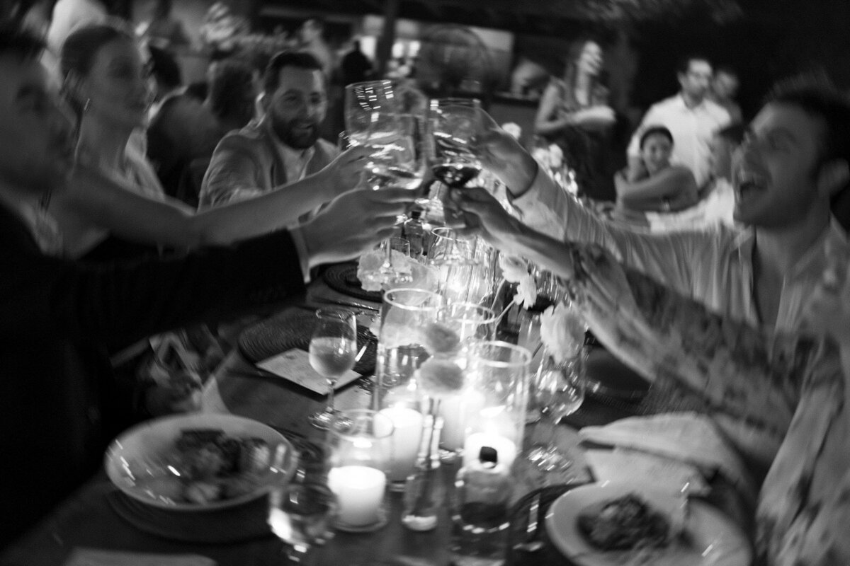 Guests toasting to the wedding couple at Rosewood Mayakoba in Tulum Mexico, by Andrea-Marie Photography