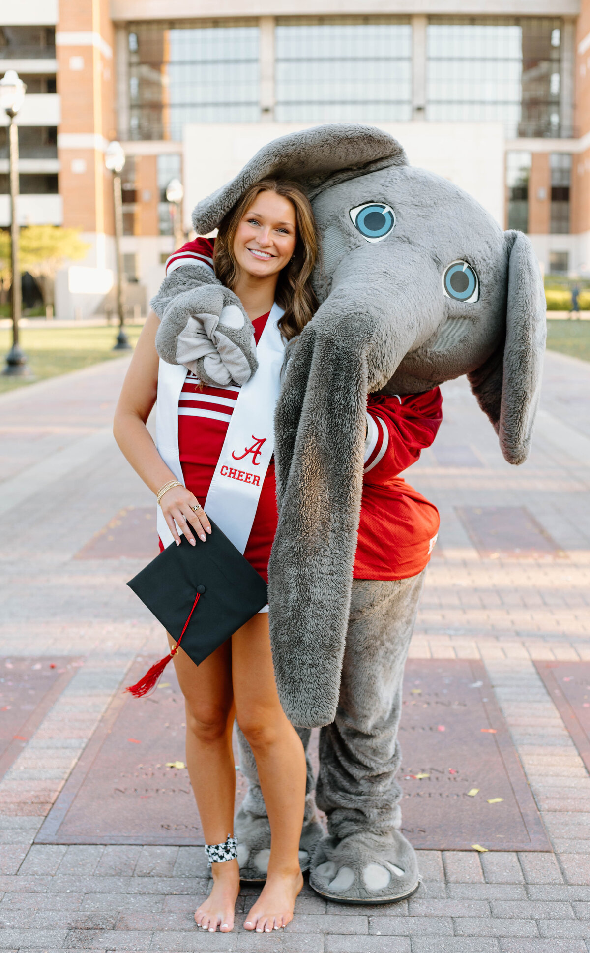 Big AL and a graduate of the university of alabama hugging and posing for a photo