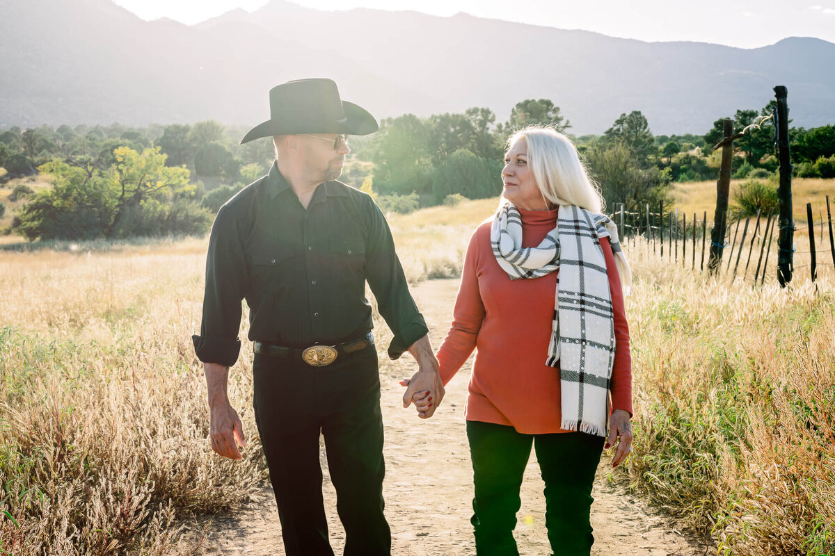 Couple walks along trail at sunset for Prescott family photographer Melissa Byrne