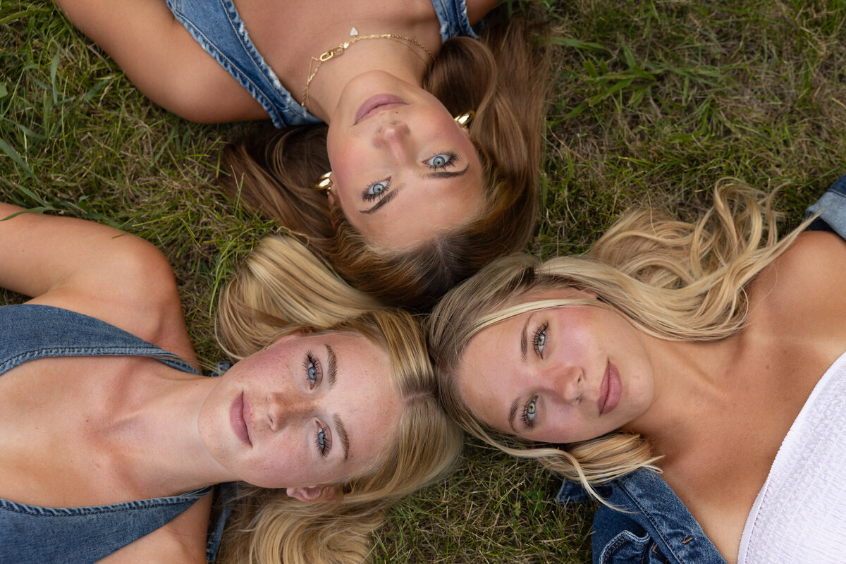 MBP Senior Team laying on the ground in a circle with their heads together in Lawrence, KS