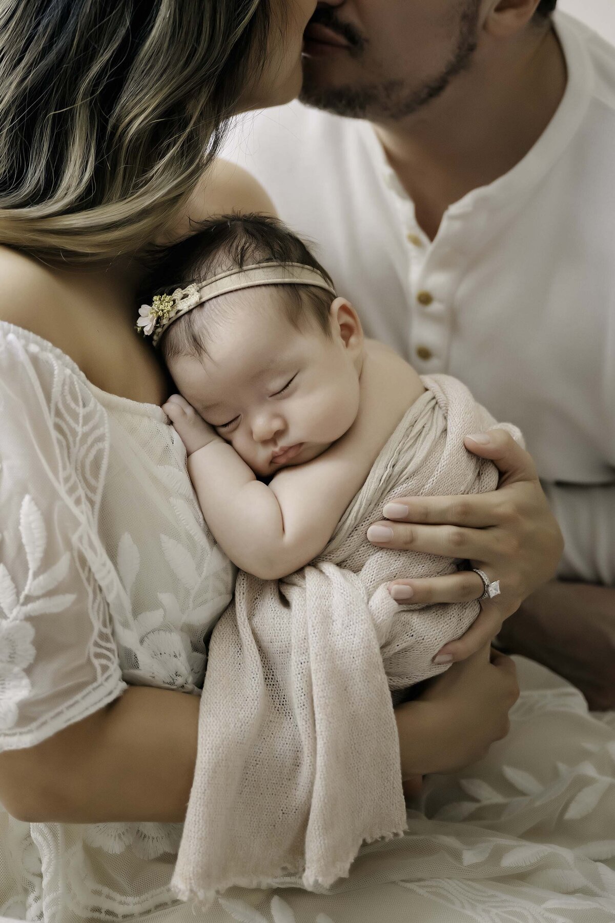 Newborn Mom and Dad Kiss