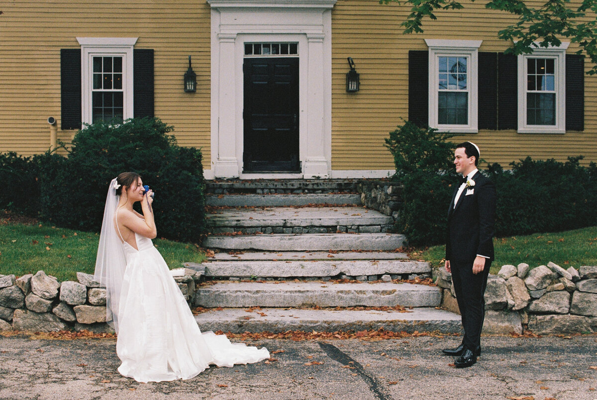 bride taking photo of groom