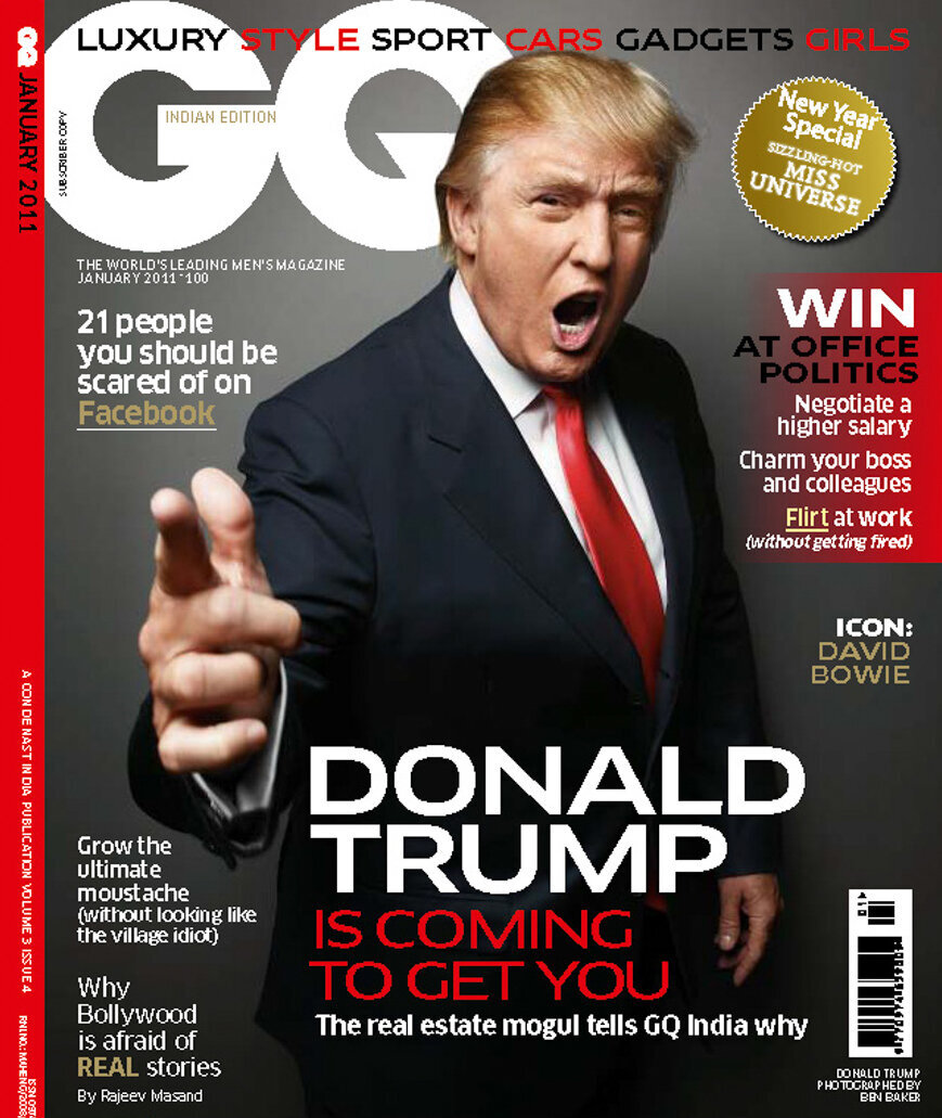 A professional portrait of President Donald Trump on the cover of GQ magazine. He is pointing at the camera, saying you are fired; he is standing in front of a grey backdrop.