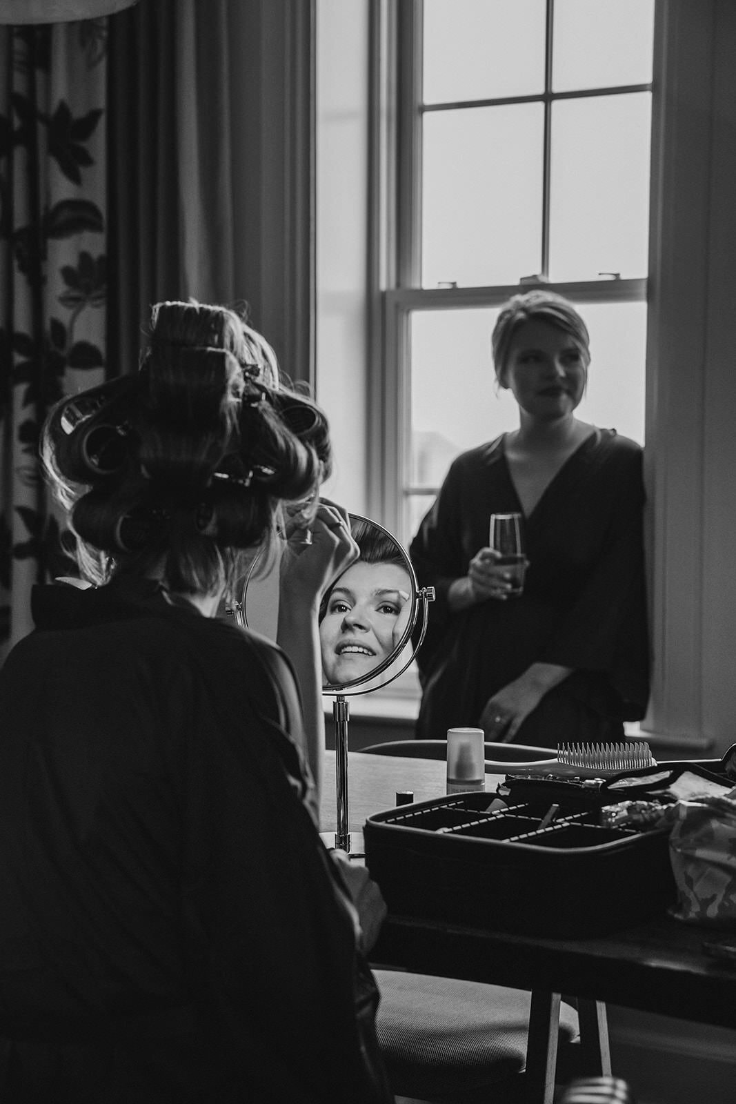 A person doing their makeup on their wedding day 