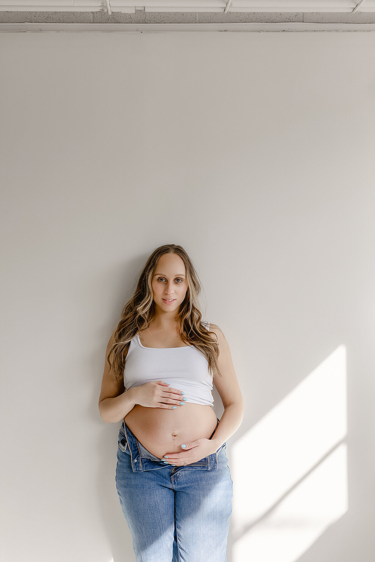 a modern studio setting with a pregnant mom