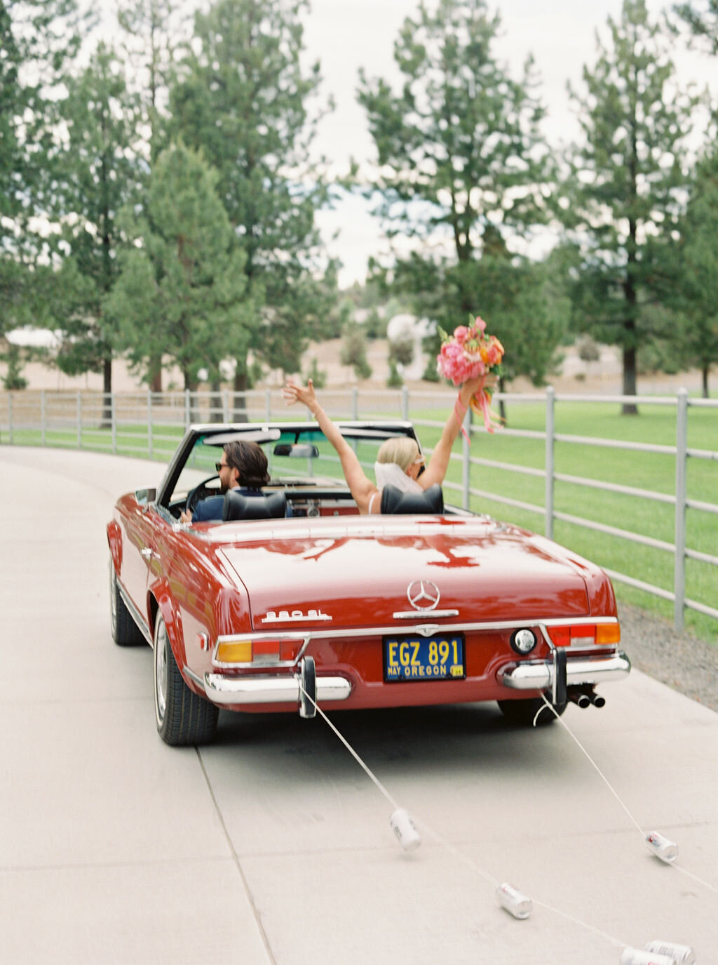 Bride and Groom in Red Convertible