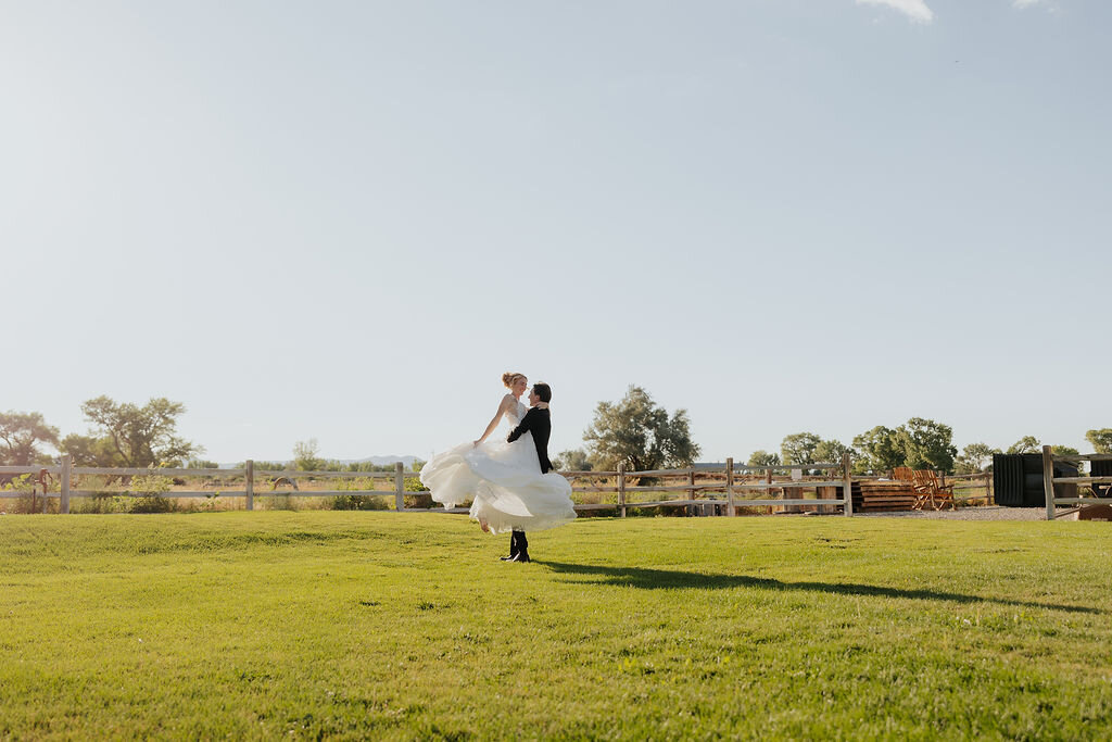 Couple twirling on the open lawn