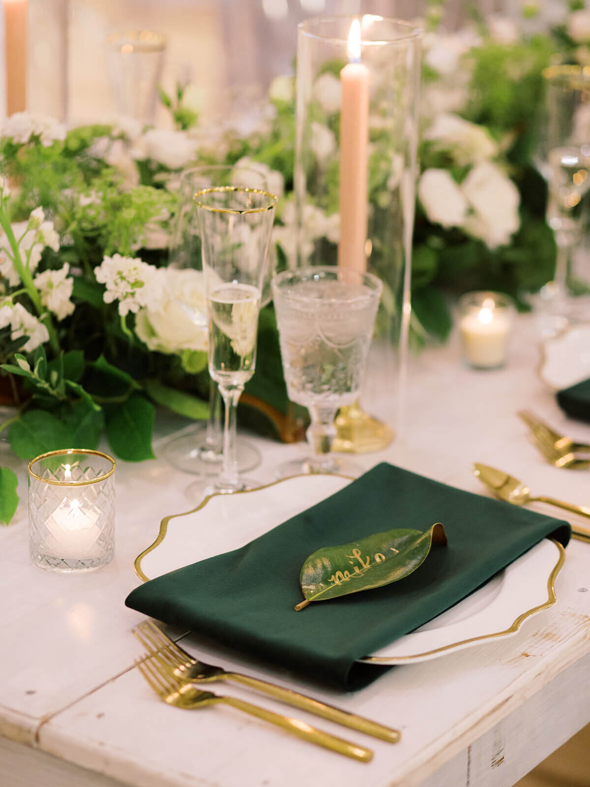 Custom emerald green wedding place settings with dipped leaves