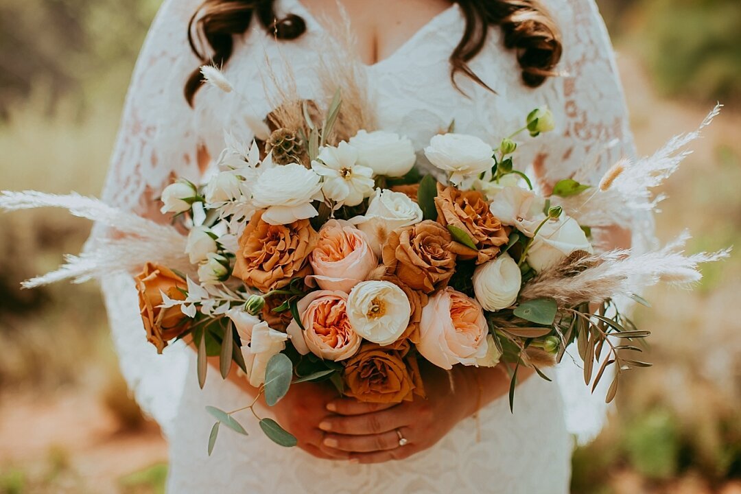 bride holds her bouquet of flowers