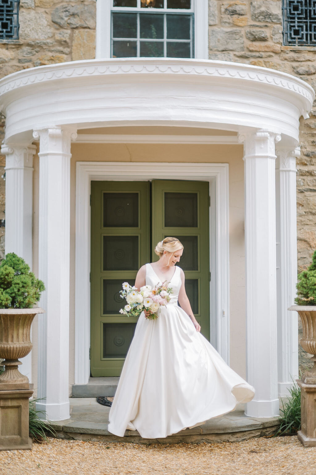 Bride standing infront of a door wearing her gown