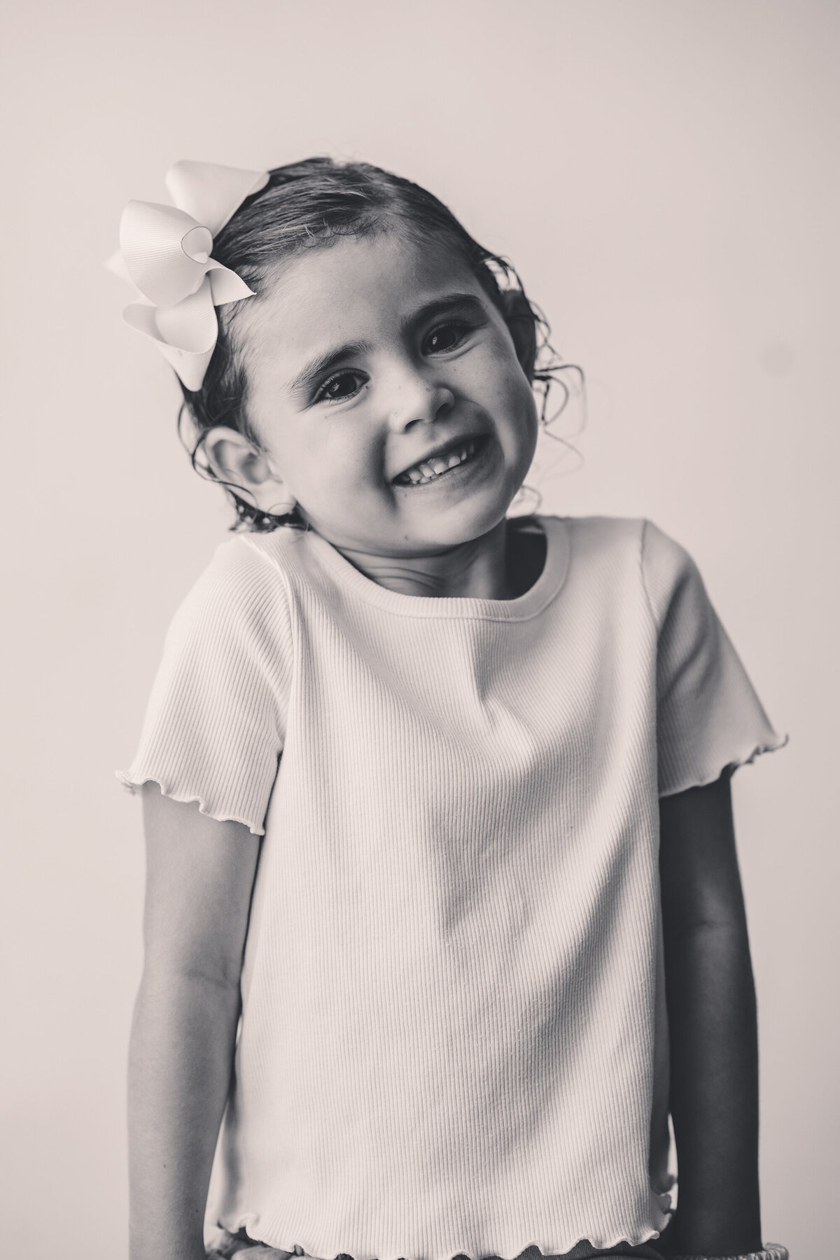 Little girl smiles at the camera during Personality Photoshoot in Charleston, South Carolina.