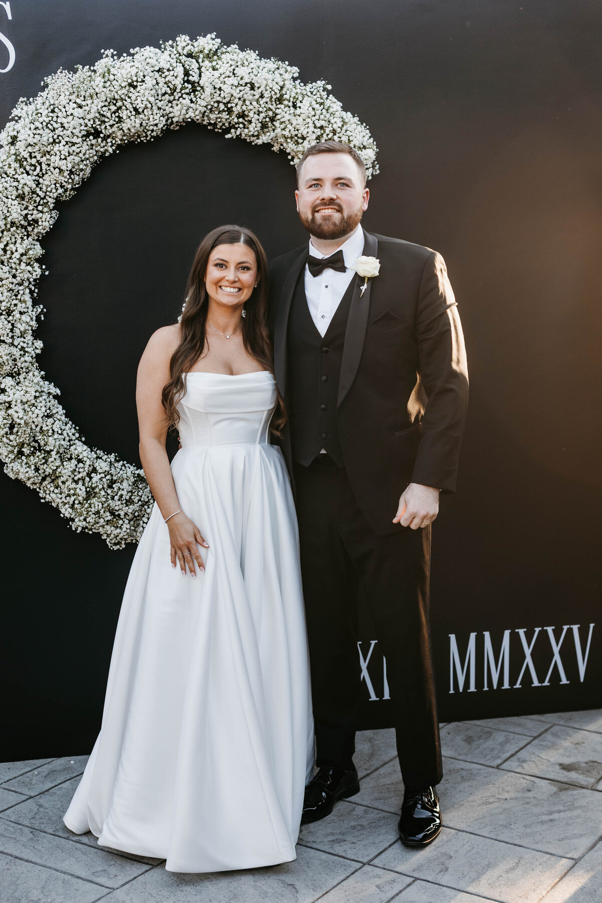 Bride and Groom in front of decor wall
