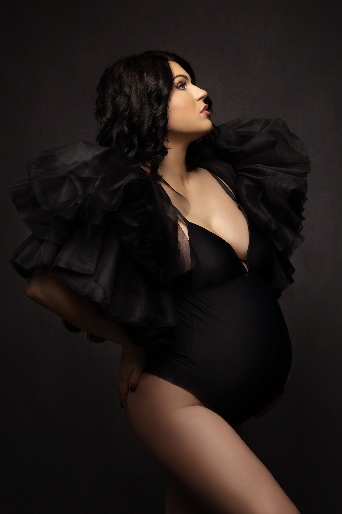Woman in dramatic black bodysuit with tulle shoulders, captured by Lindsay Walden Photography in Dallas.