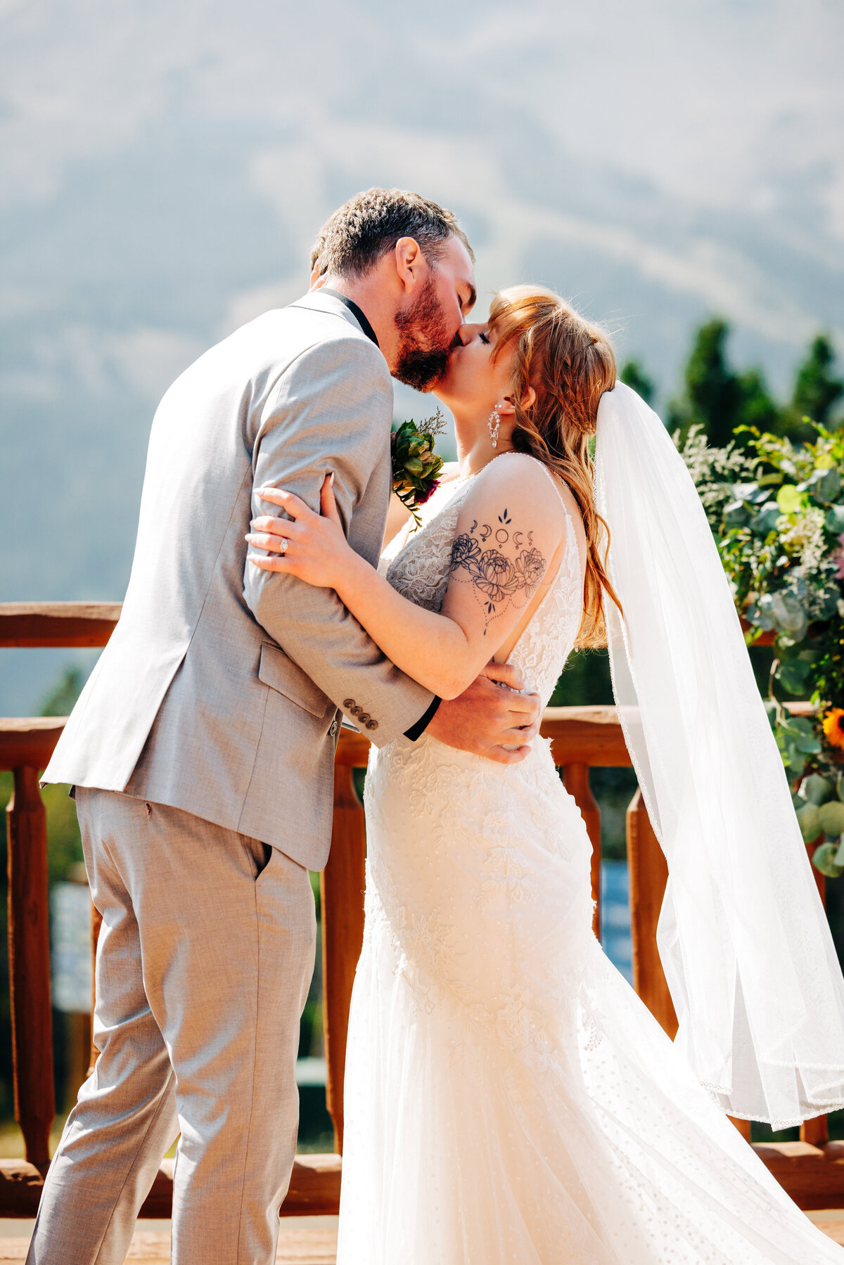 Bride and groom ceremony kiss on patio at Everett's 8800 in Big Sky, MT