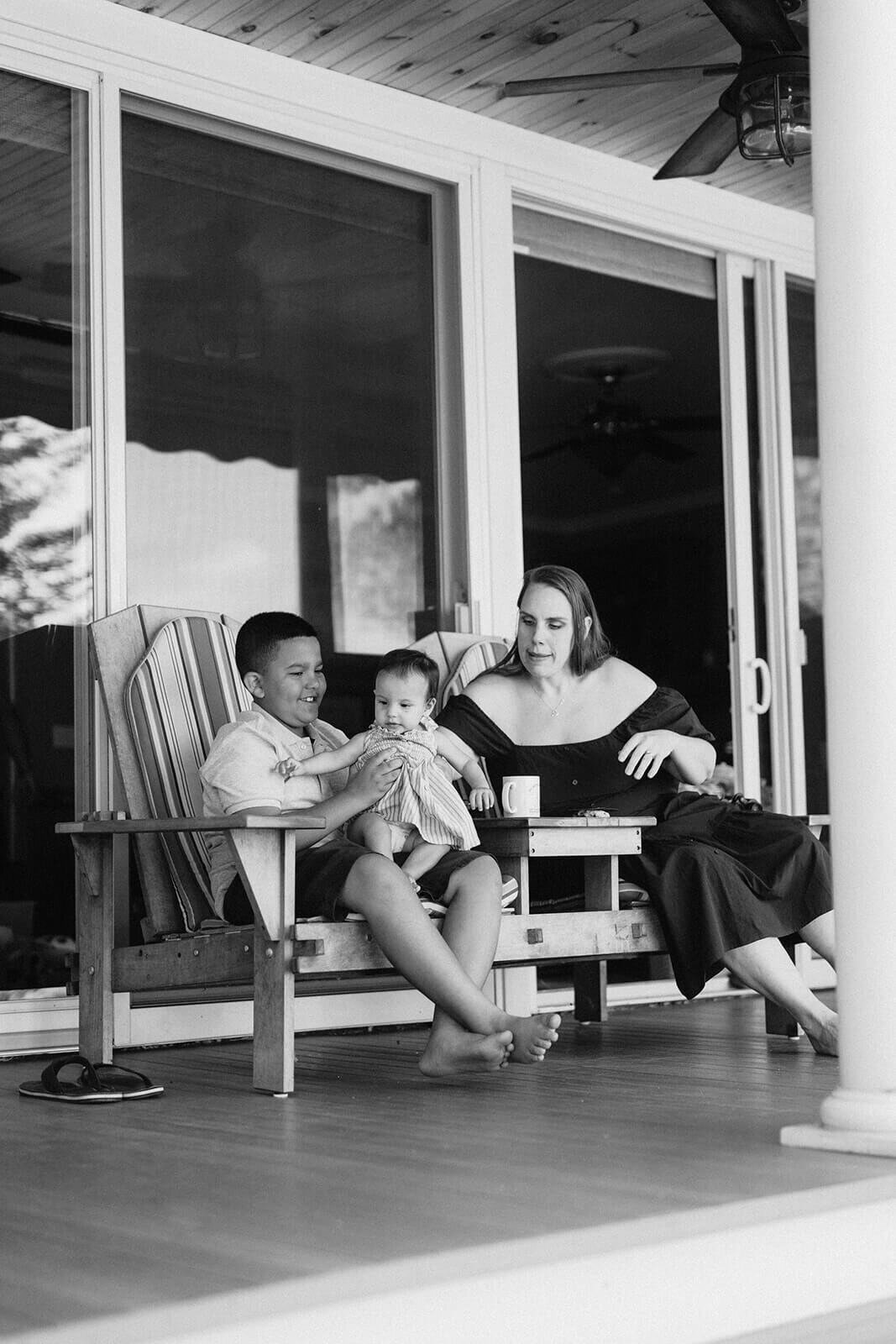 Mother with child holding a baby on his lap at generational photoshoot in Finger Lakes, NY