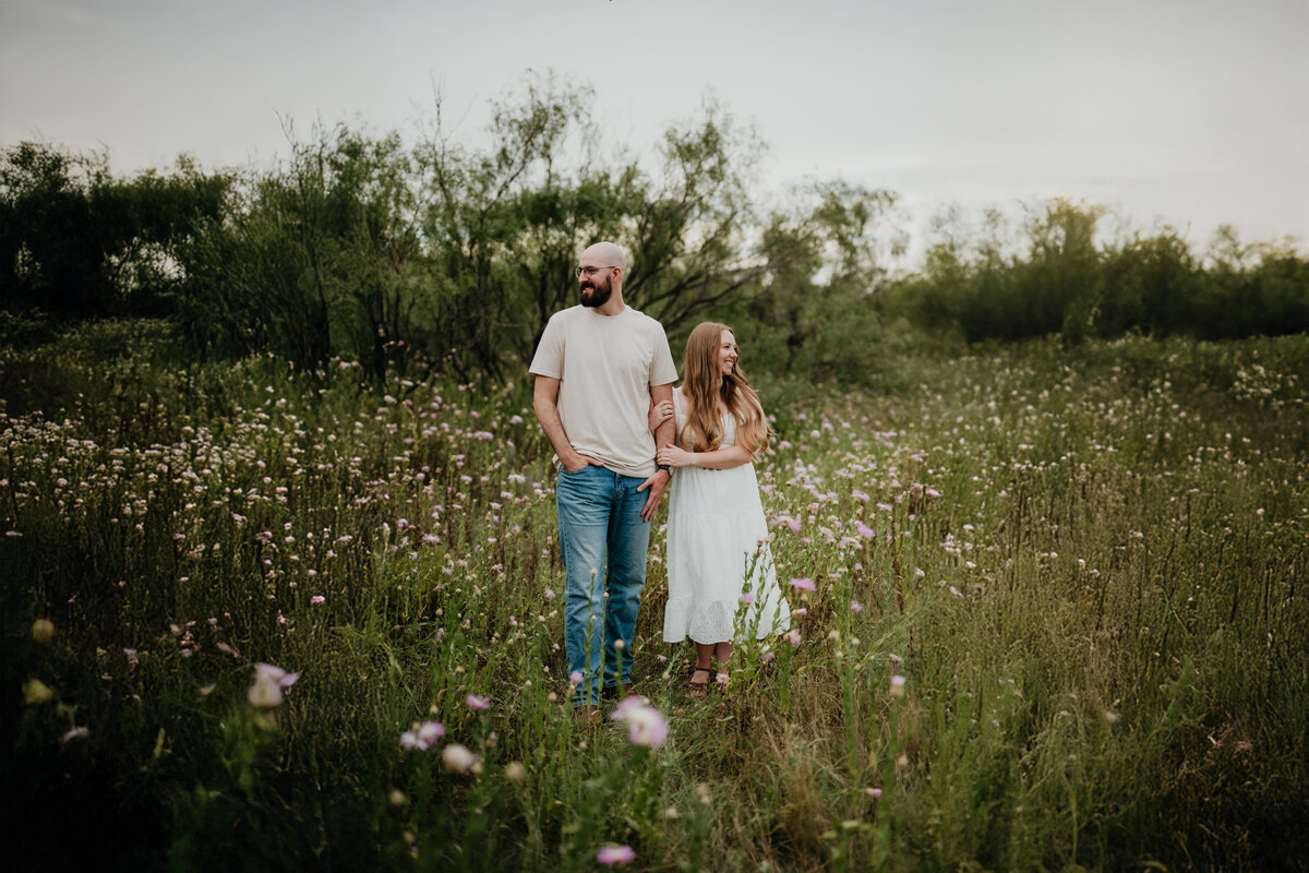 couple standing in flower field in palo duro canyon, Emily wheeler photography