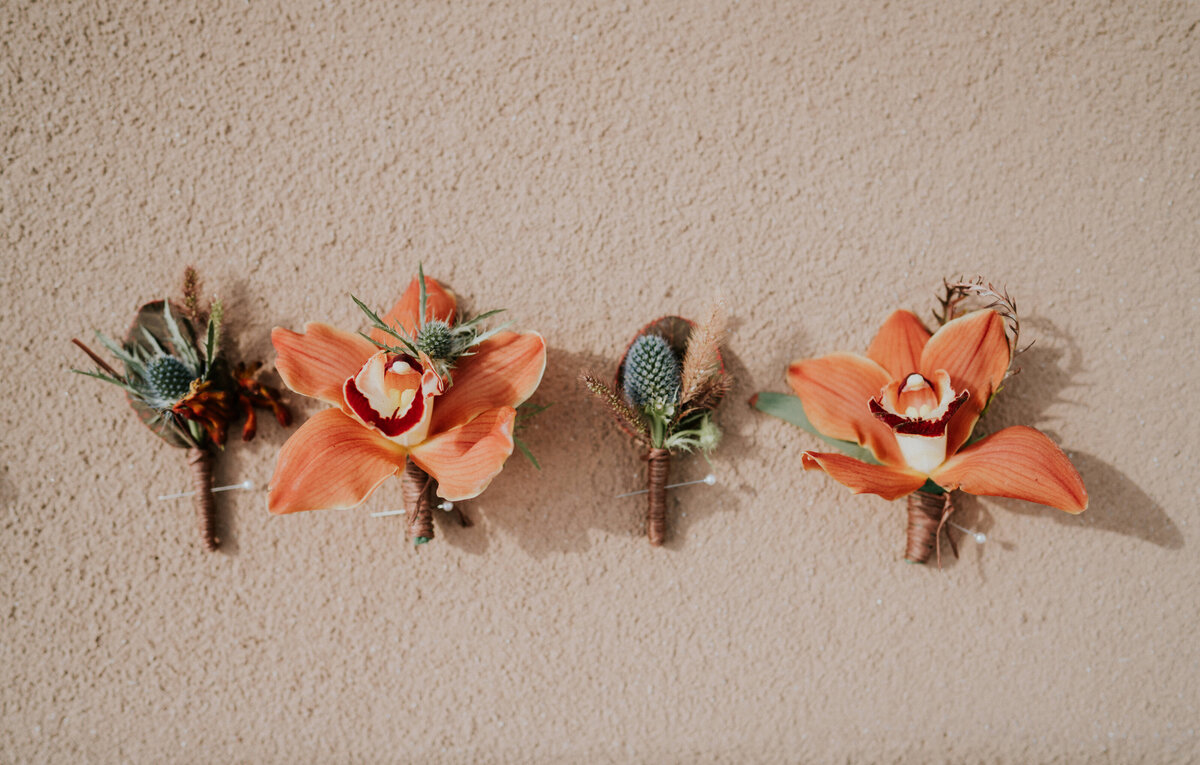 Southwestern peach and blue boutonnieres.