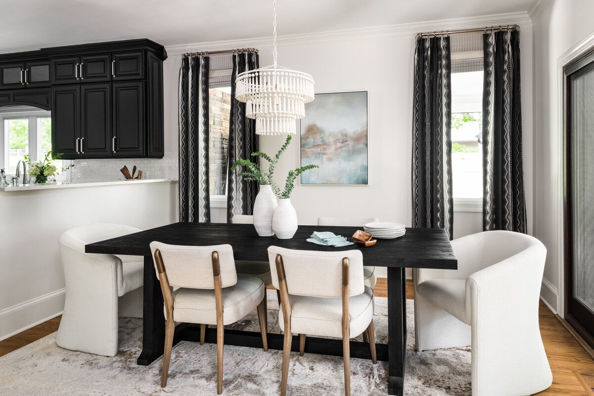 Open-concept kitchen and dining space in Lake Norman, NC, blending dark cabinetry with warm wood tones.