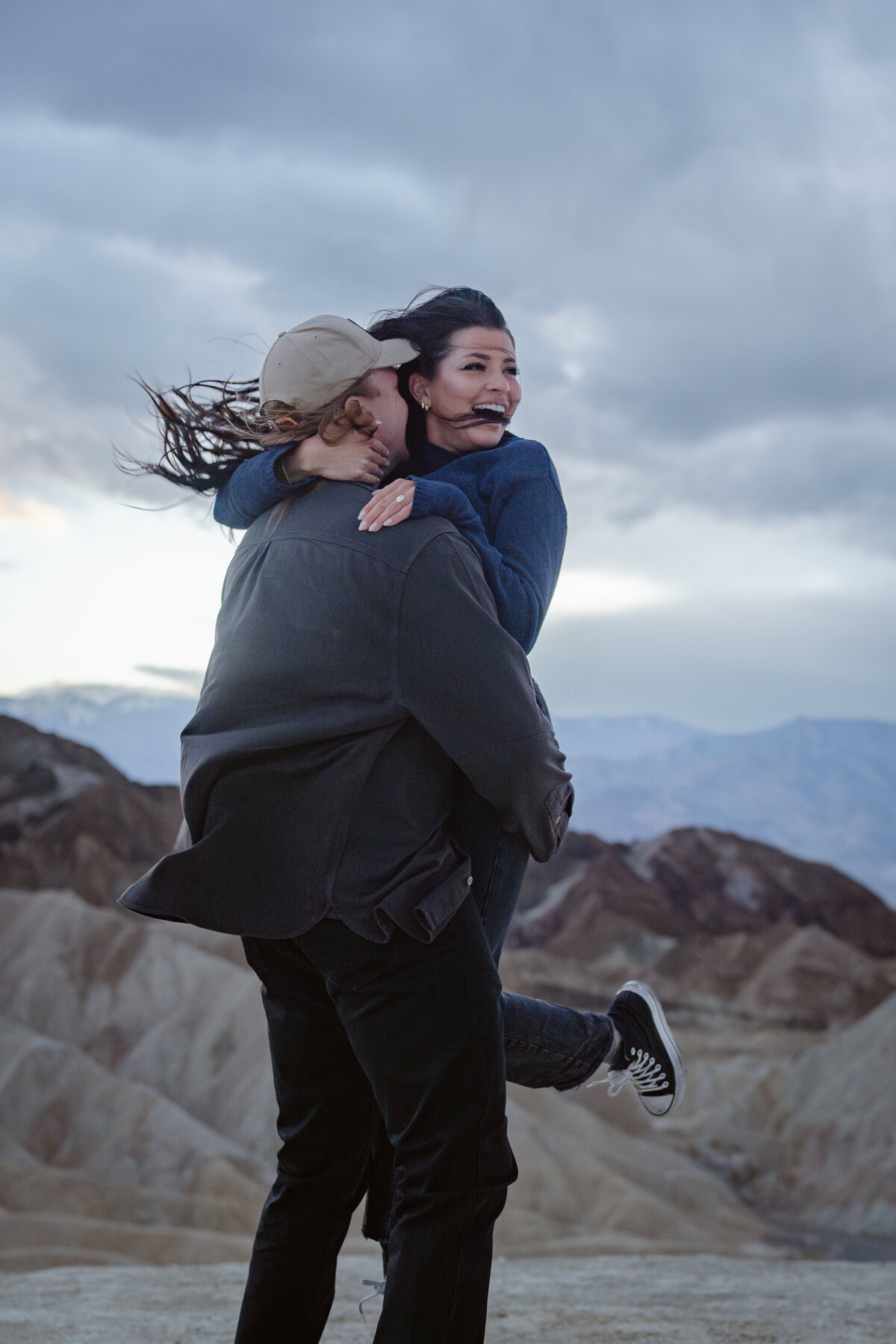 A person holding their partner up and spinning them around