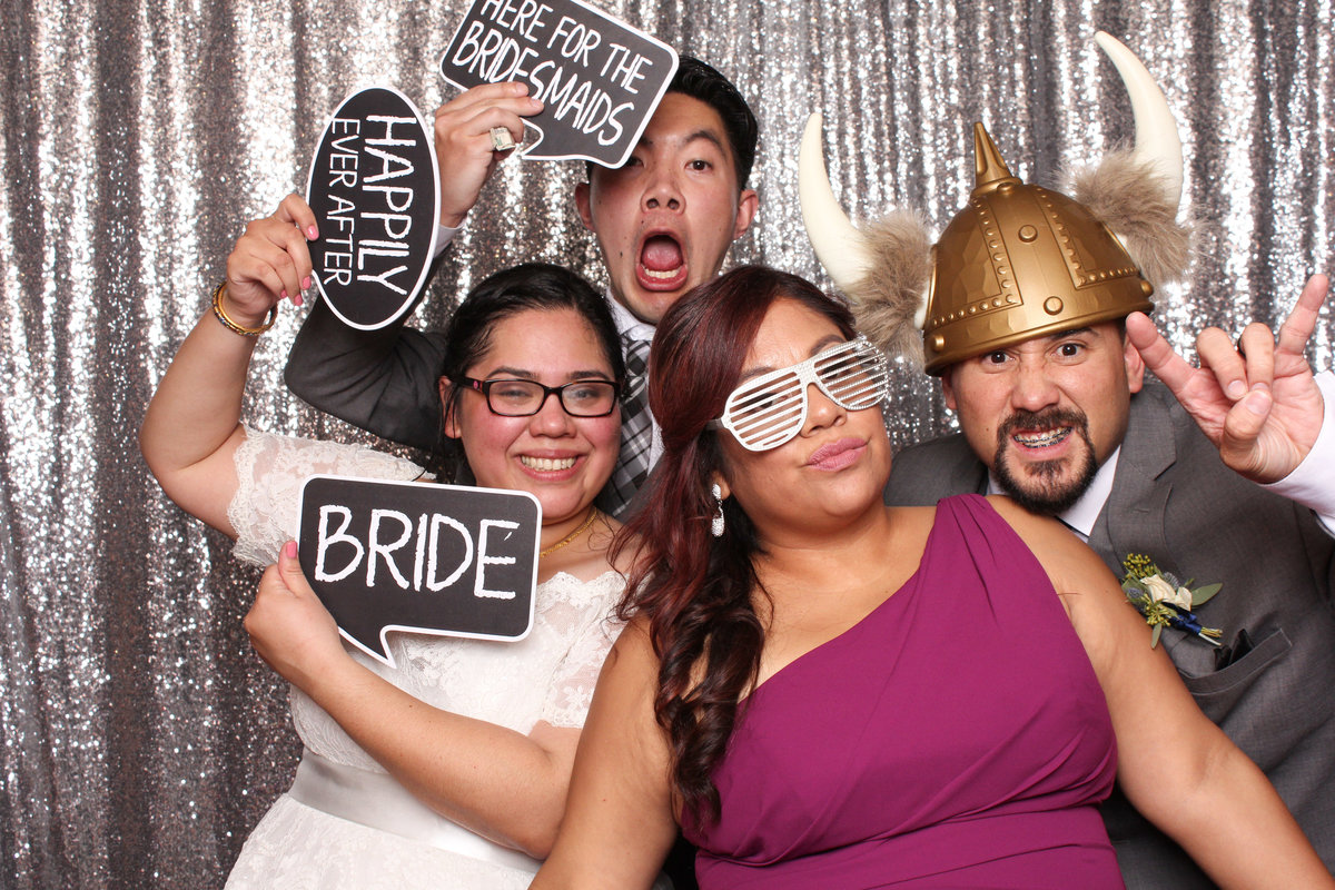 Wedding guests acting goofy in a photo booth