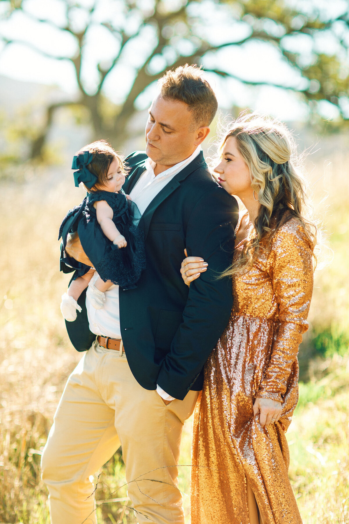 Family Portrait Photo Of Mother Leaning To Her Husband Who's Carrying The Baby Los Angeles