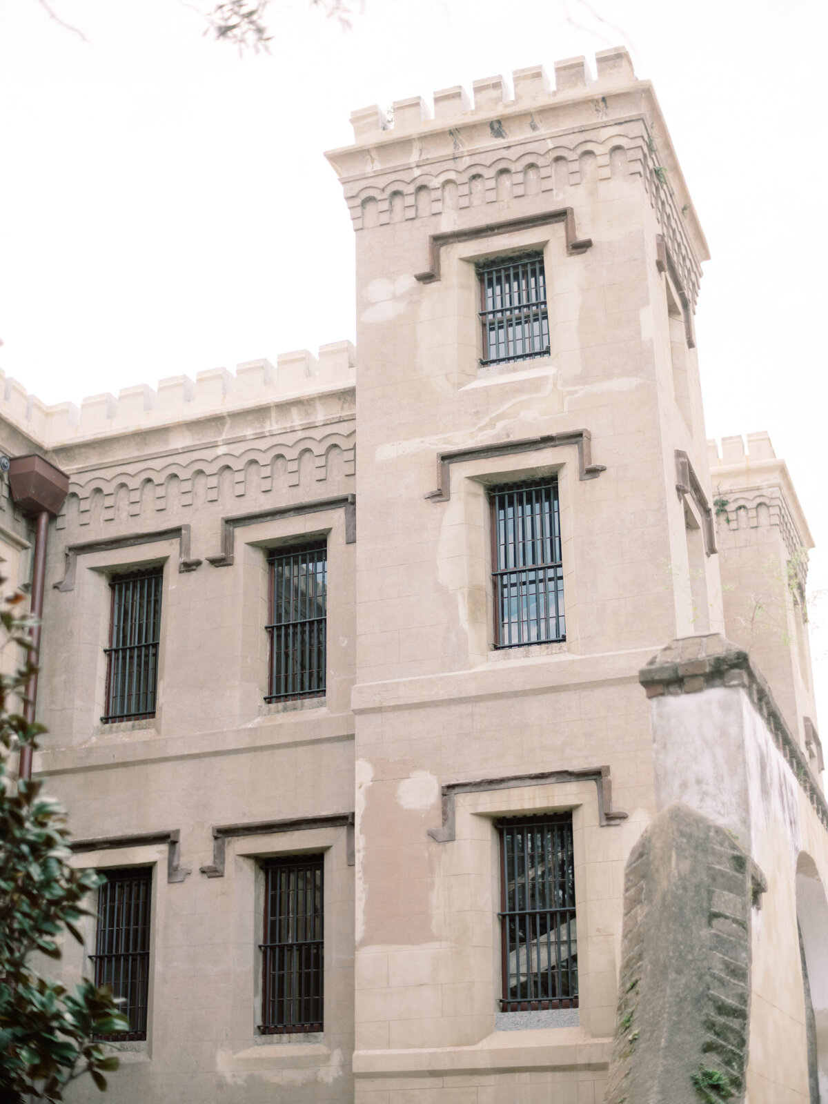 This image captures a historic castle-like structure featuring decorative architecture and iron-barred windows, emphasizing a blend of beauty and security in design.