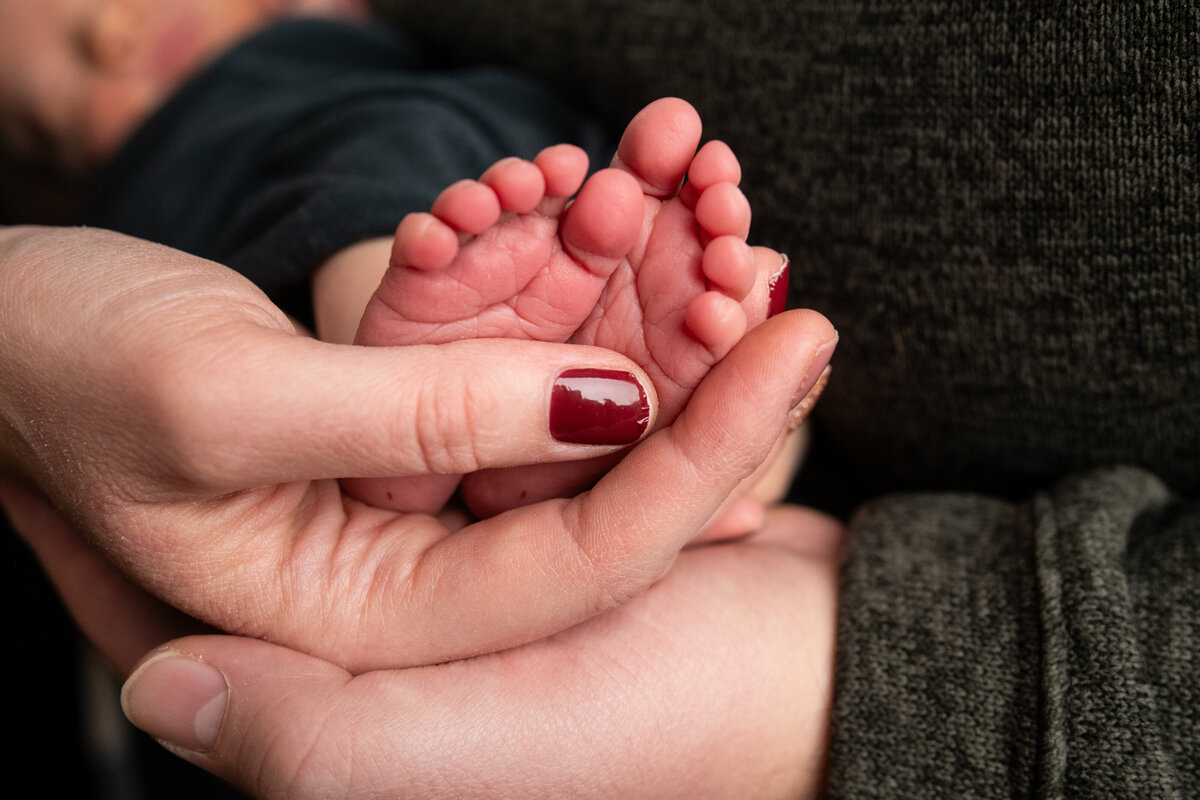 Baby's feet in parent's hands