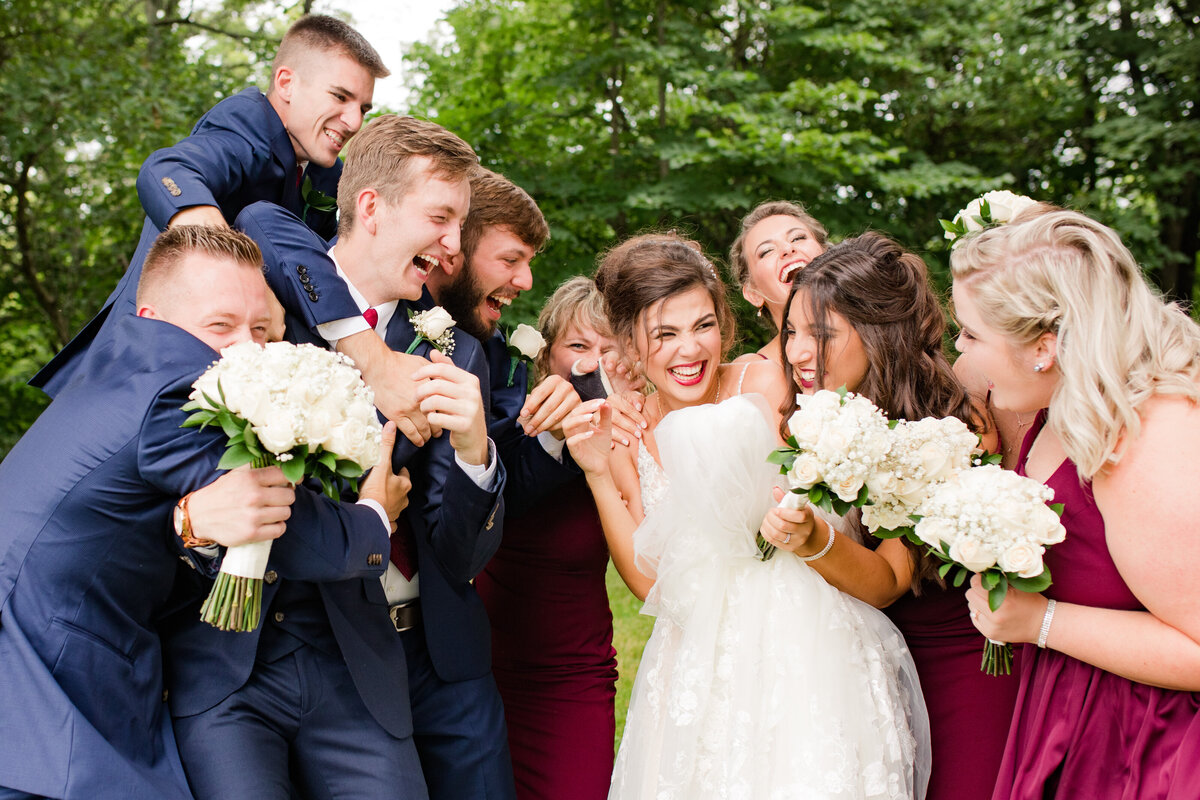 Bride and groom celebrate with their bridal party at the Ironwood wedding venue in Lasalle, Illinois.
