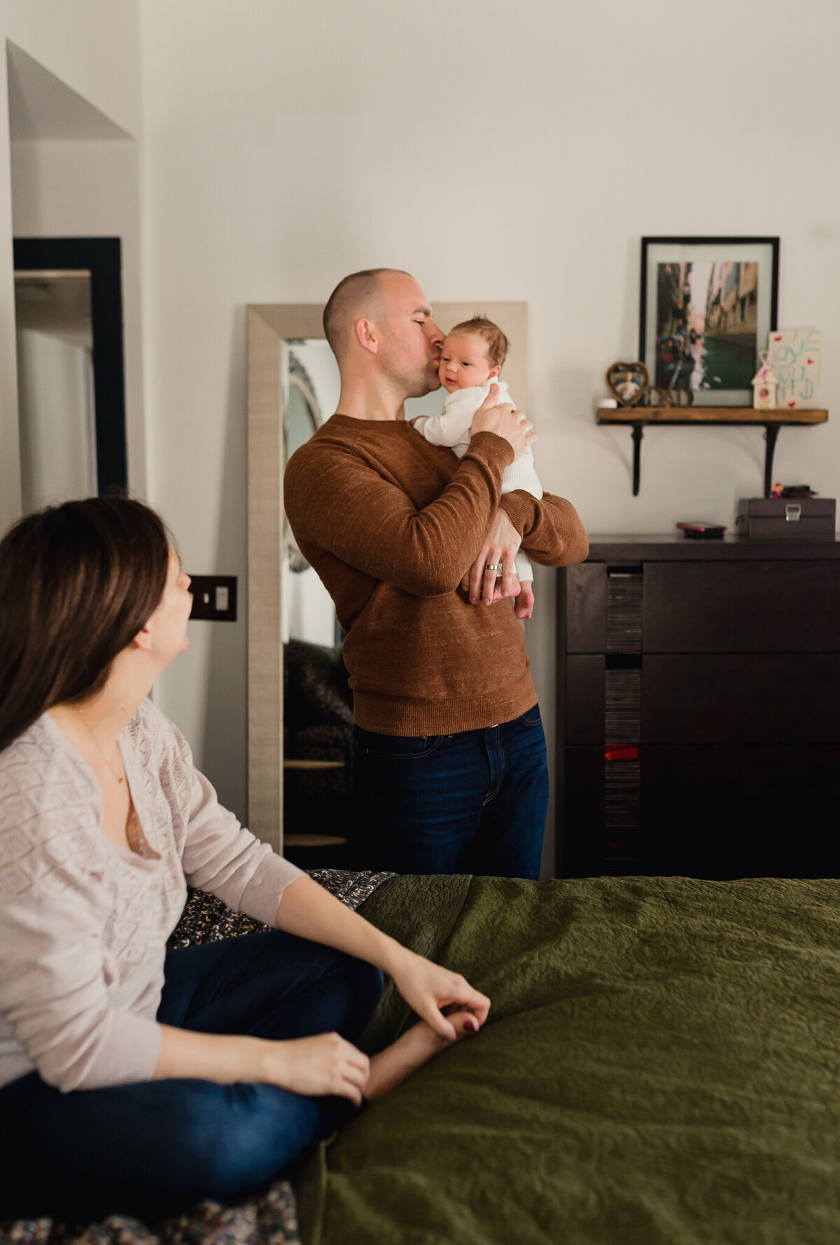 Family Photoshoot Session with mom, and dad holding newborn baby.