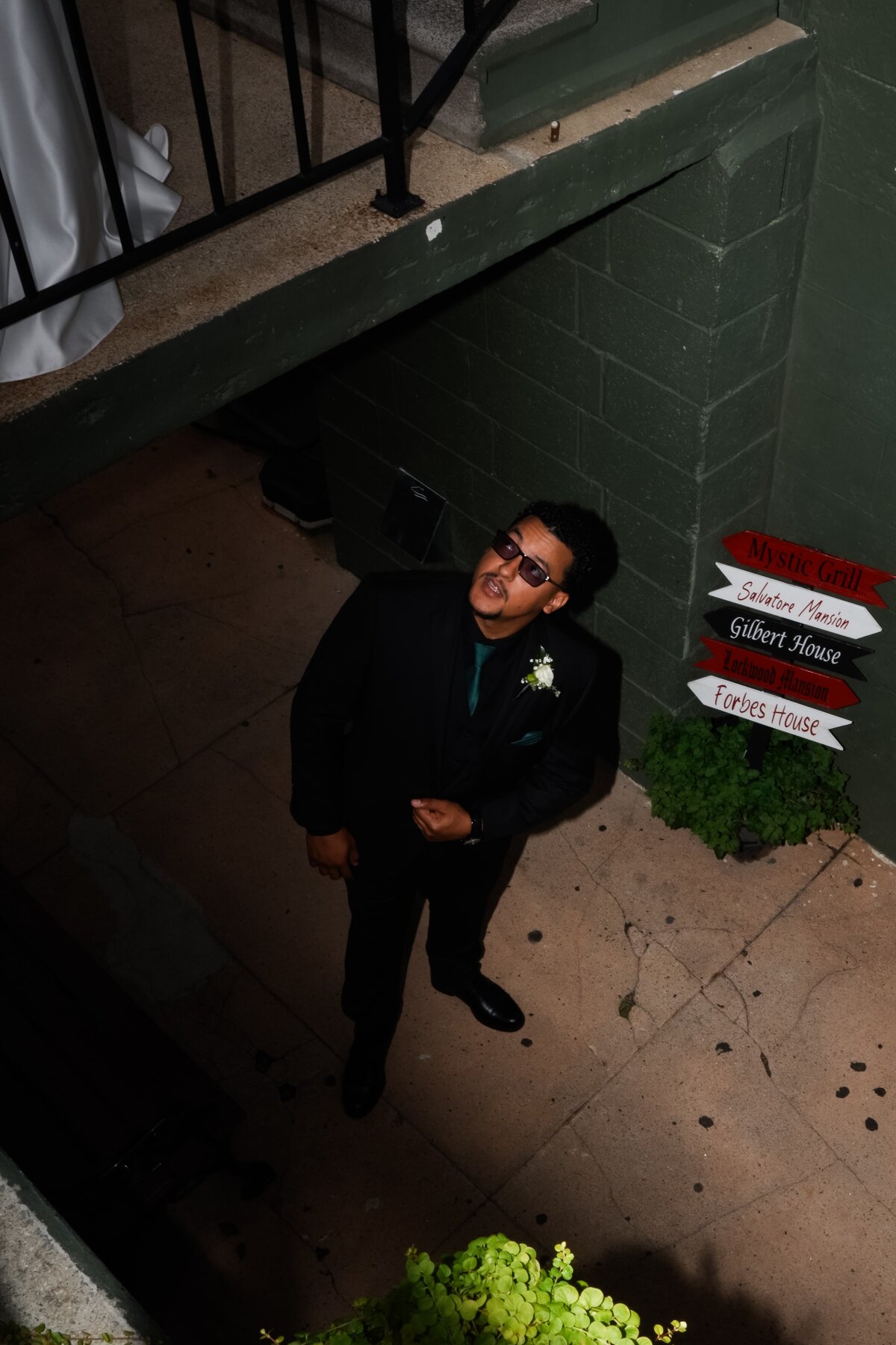 Groom looking up outdoors.