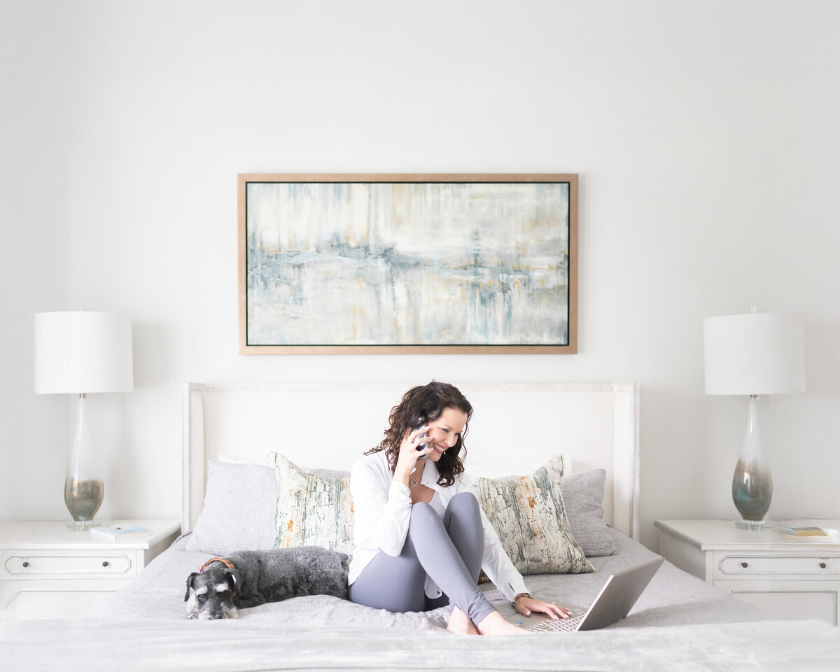 woman business owner on bed working helping client
