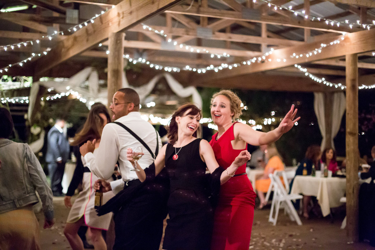 wedding guests dancings at outdoor wedding reception at the venue Oak Valley Vineyards in Garden Ridge