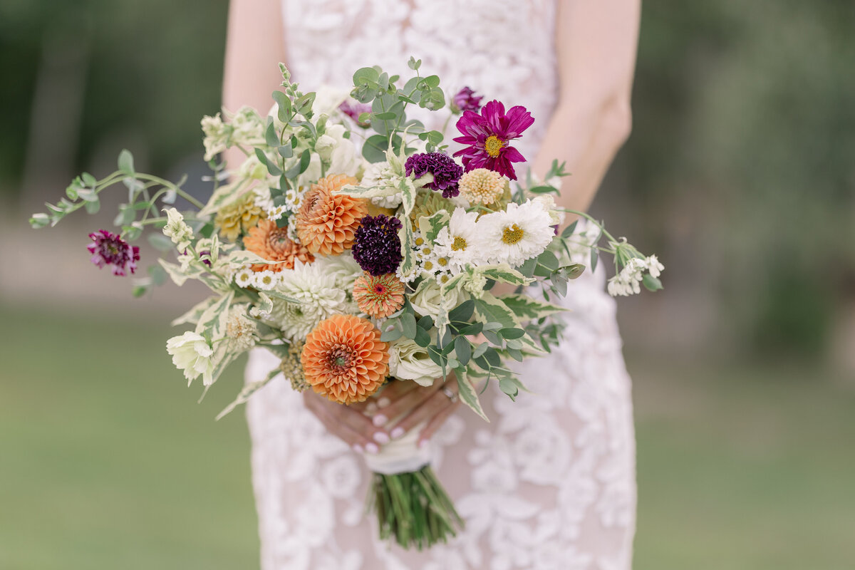 bridal bouqet with orange, purple and white florals