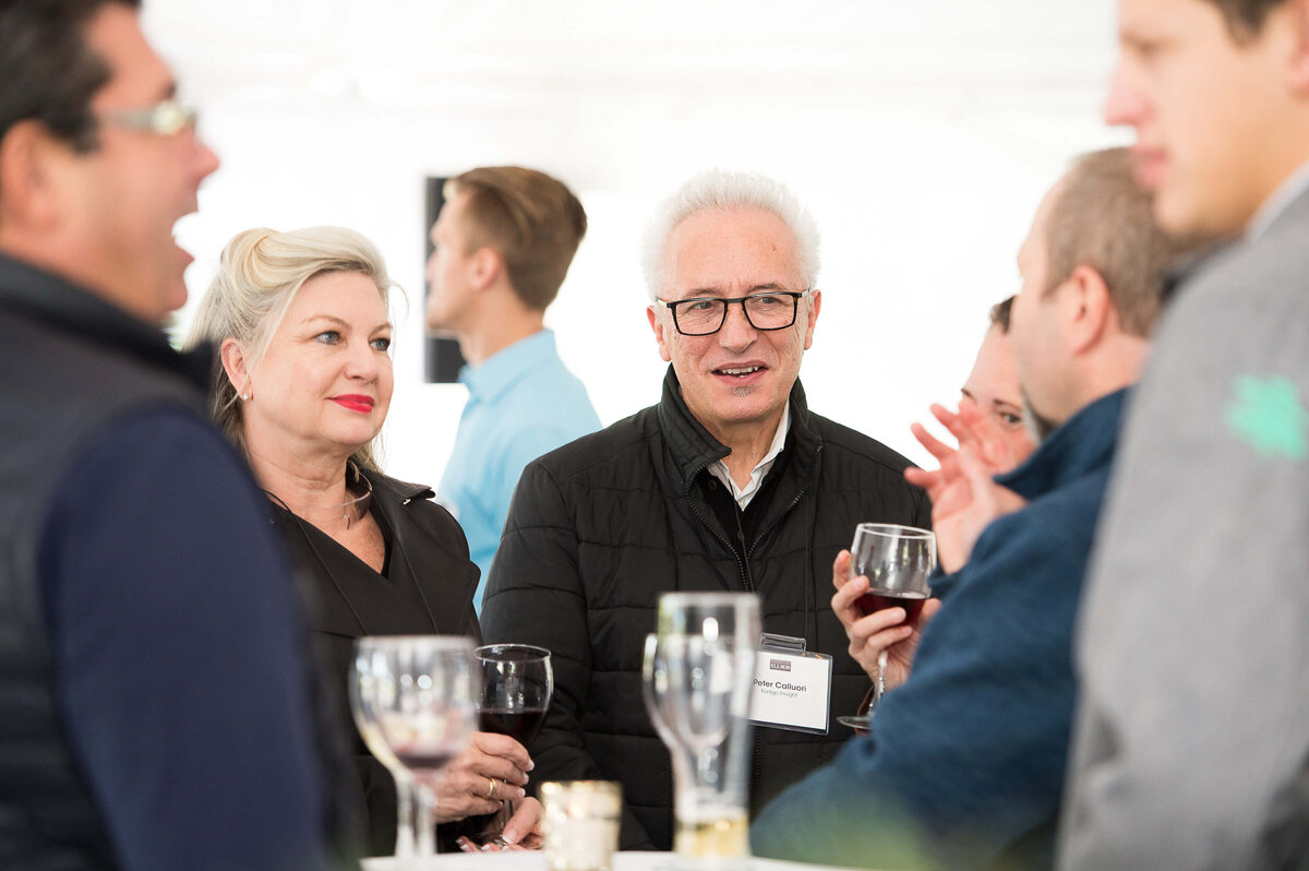 a candid photo of guests mingling at a corporate anniversary celebration.  Captured by Ottawa Event Photographer JEMMAN Photography COMMERCIAL