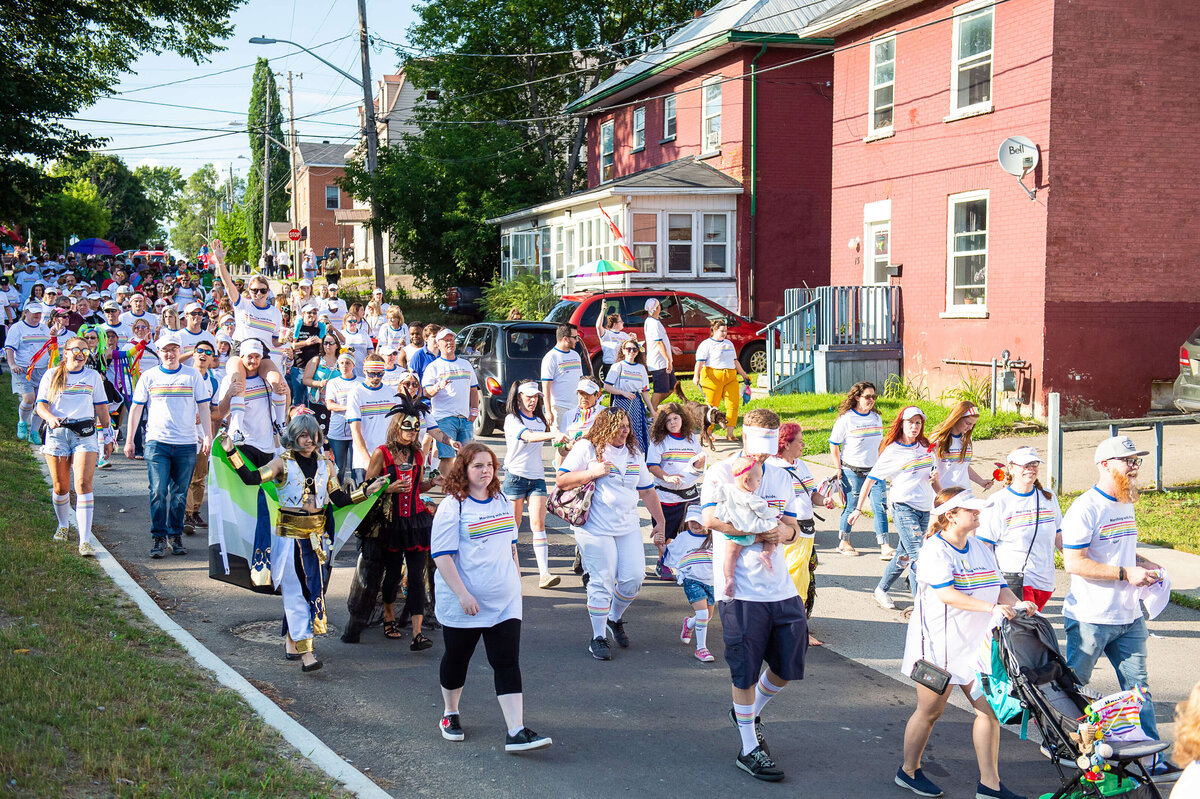 Tweed organizers of the Pride Parade driving a truck and waving a flag.  Captured by Ottawa Event Photographer JEMMAN Photography COMMERCIAL