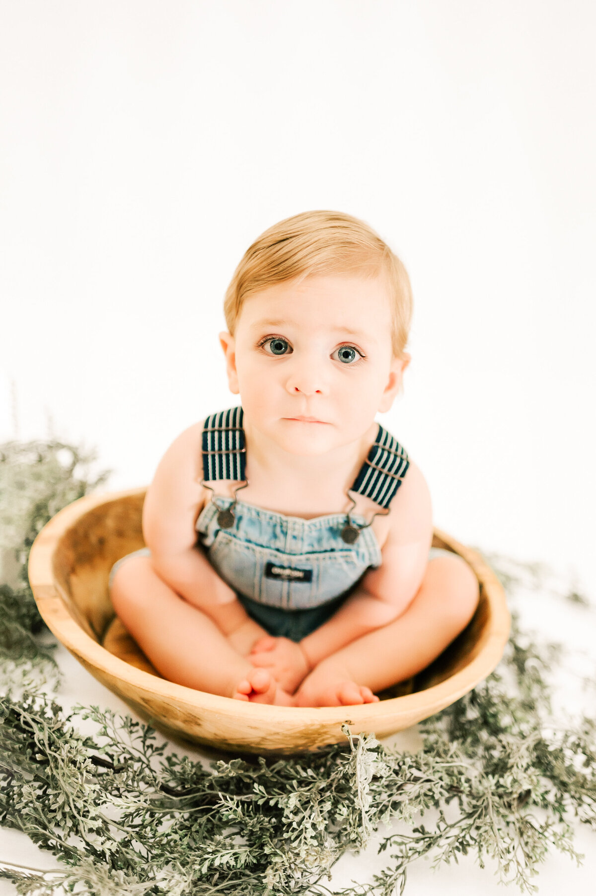 Springfield MO kids photography of toddler boy sitting in bowl serious