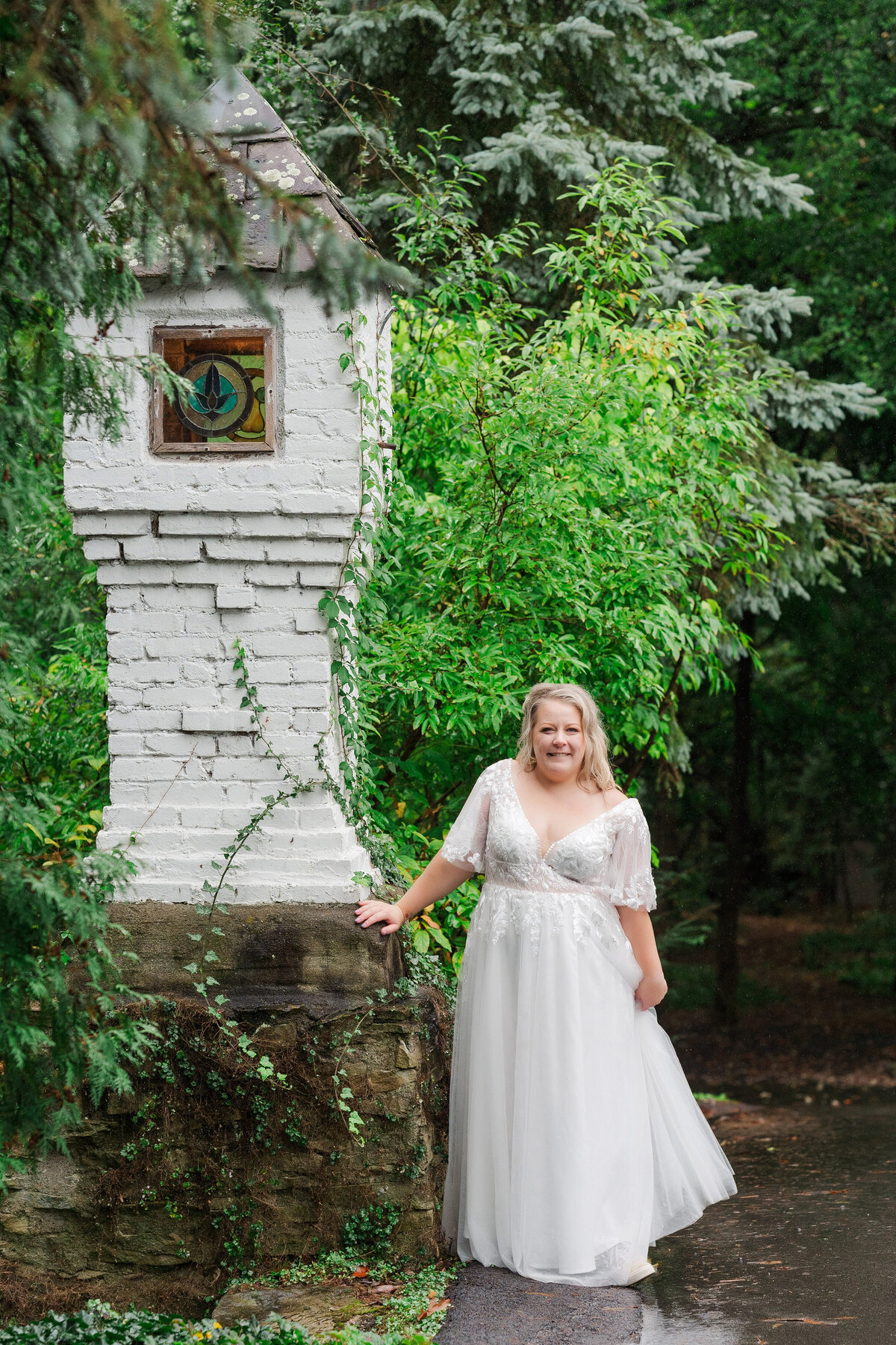 bride posing for a photo by the stonework magical picture Hyeholde