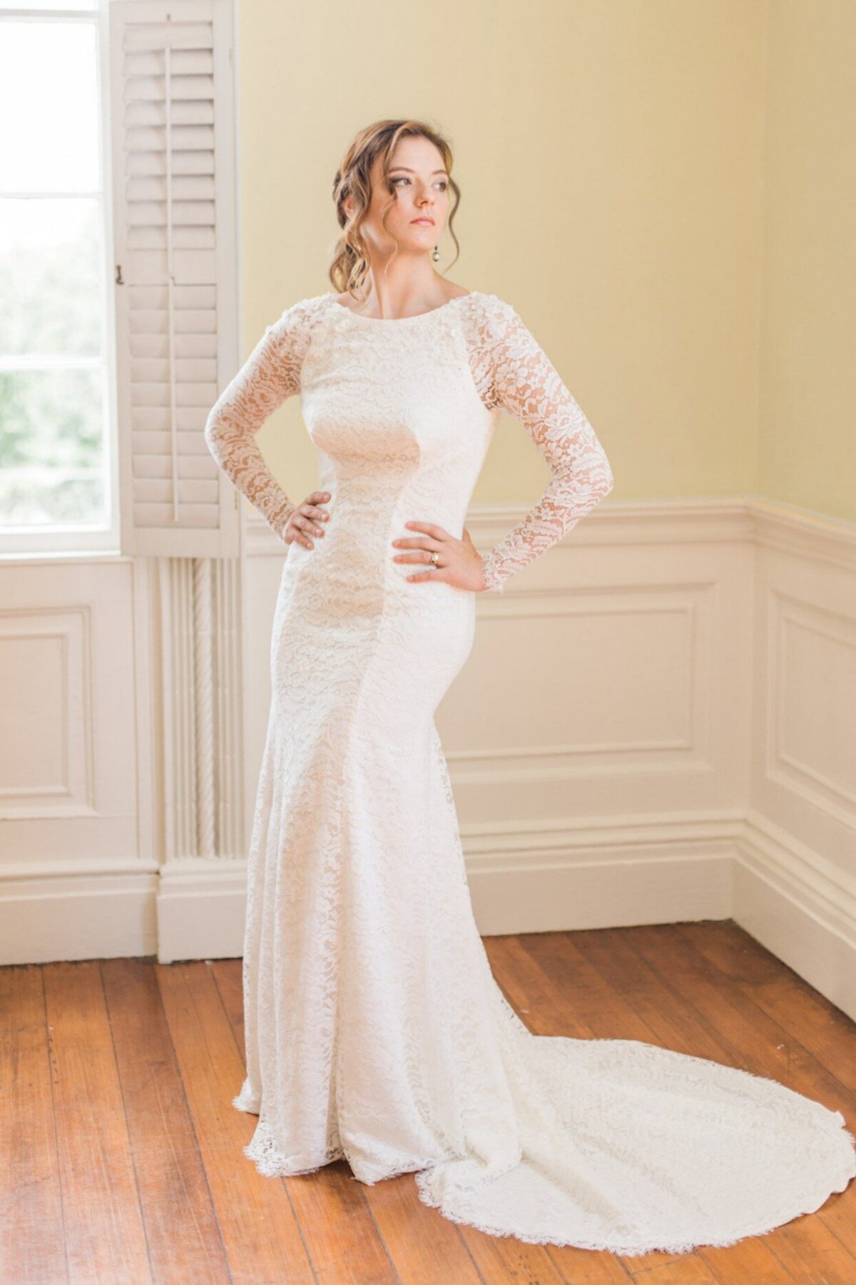 Hudson is a crepe and lace wedding dress with long sleeves in a subtle fit-and-flare silhouette by bridal designer Edith Elan.