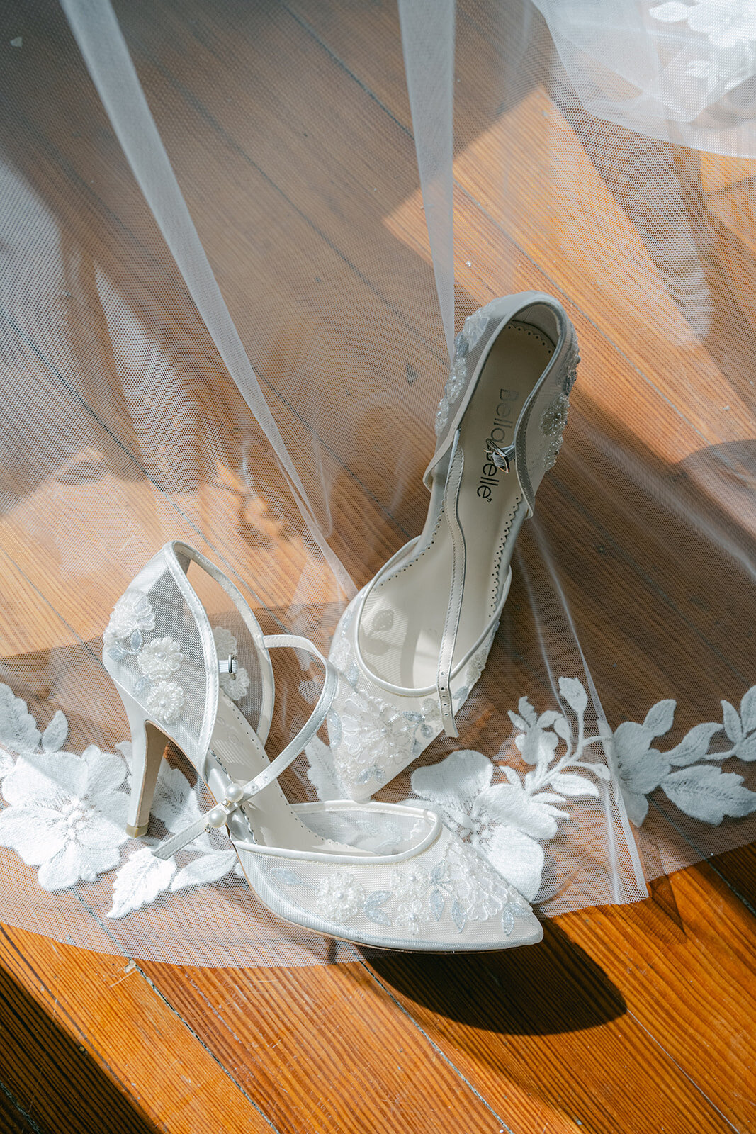 Close-up of bridal heels with lace veil captured in an elegant detail flat lay at San Antonio wedding