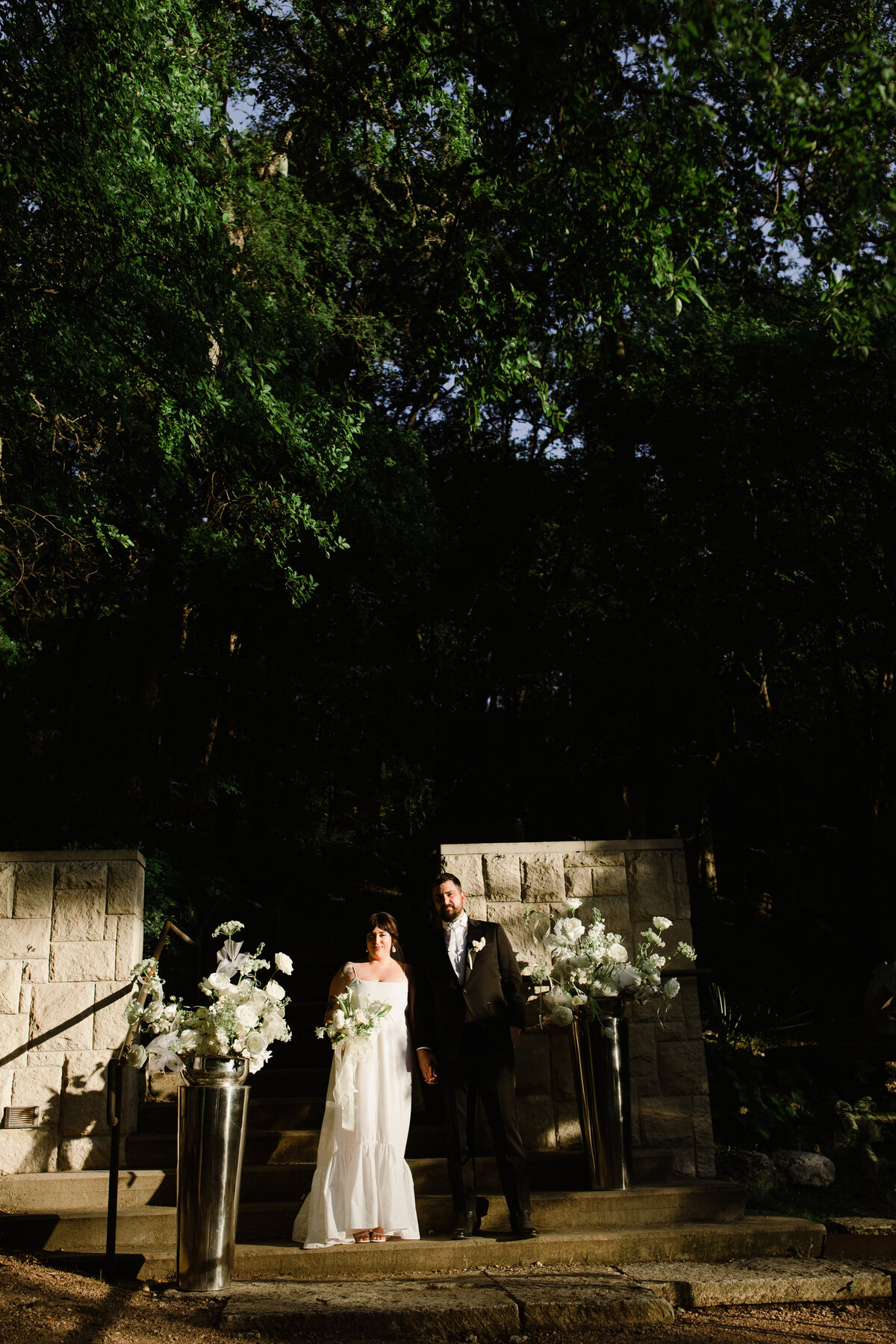 Bride and groom at ceremony site at night at Couple portraits in the grounds of Umlauf Sculpture Garden, Austin