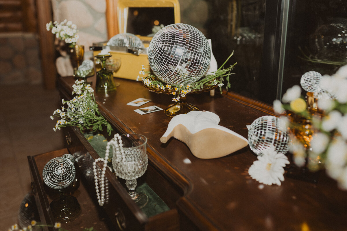 wedding details with shoes and disco balls and polaroid pictures