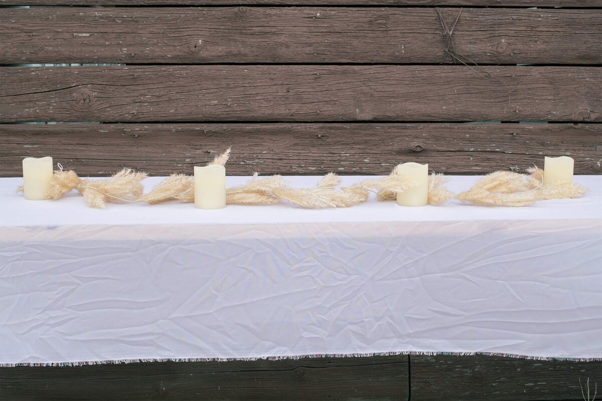 faux wheat strand on table with candles