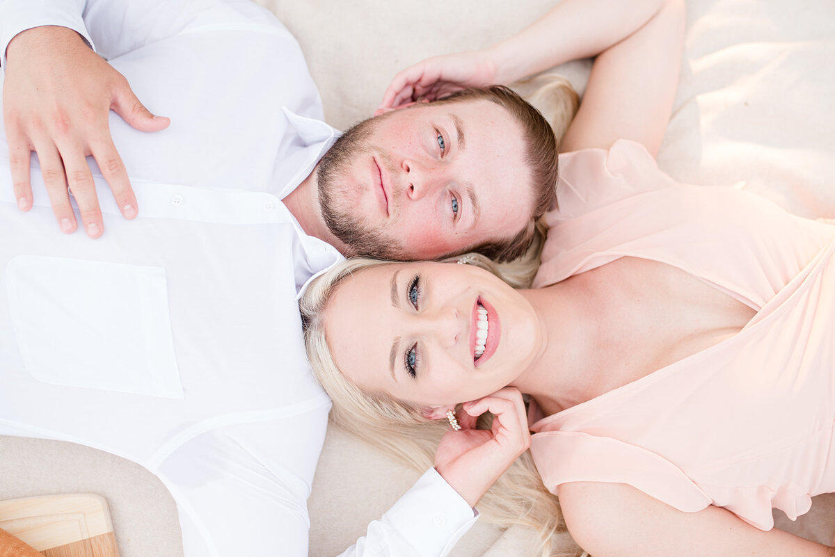 couple laying down on picnic