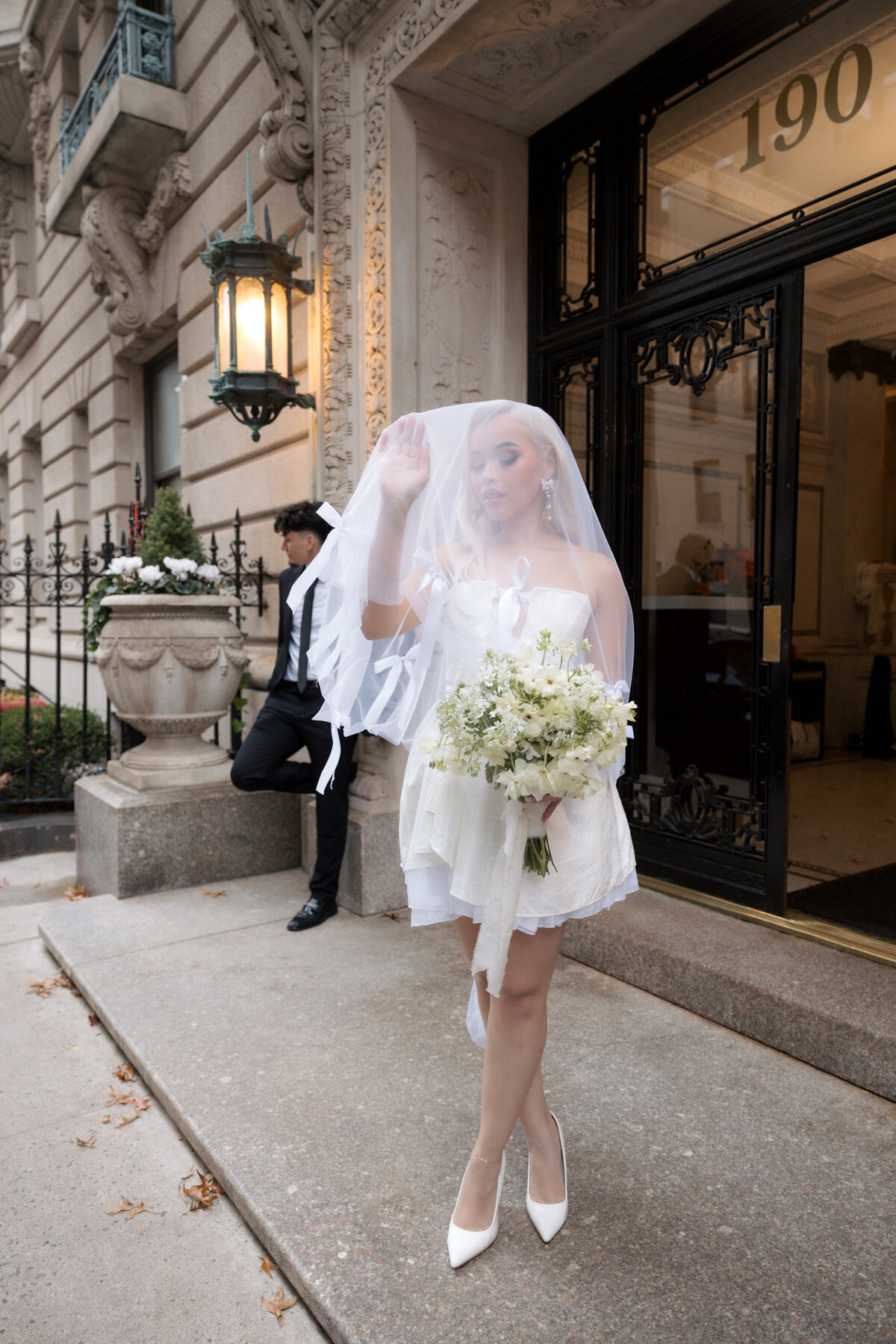 Close-up shot of the bride’s bouquet with NYC streets softly blurred in the background.