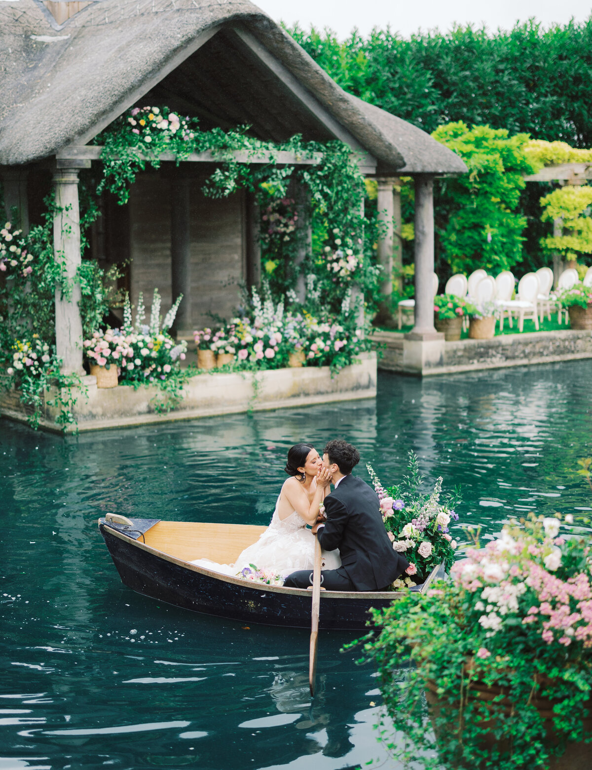 Bride and Groom in lake kissing with flowers