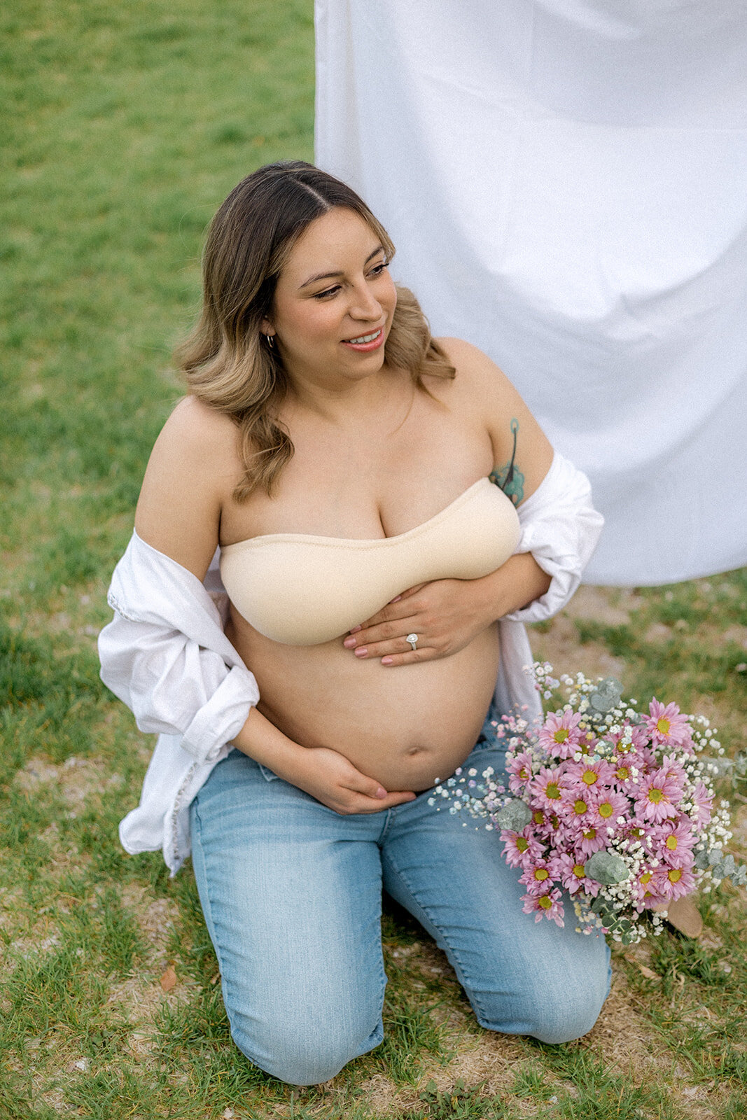 A pregnant woman is happy while holding her belly
