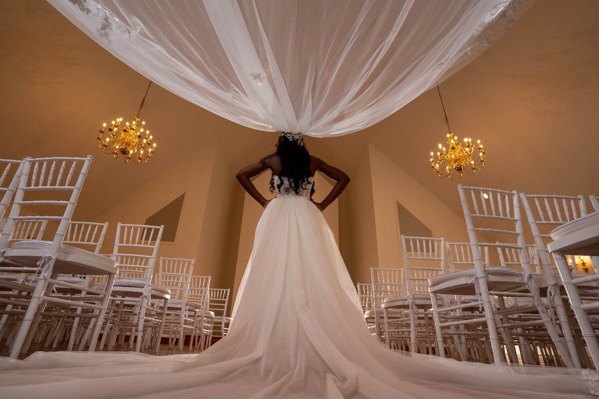 bride-stands-alone-in-chapel-with-veil