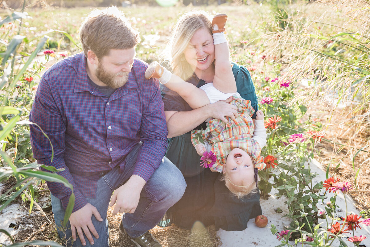 Family in flowers holding child upsidedown, Austin Family Photographer, Tiffany Chapman Photography