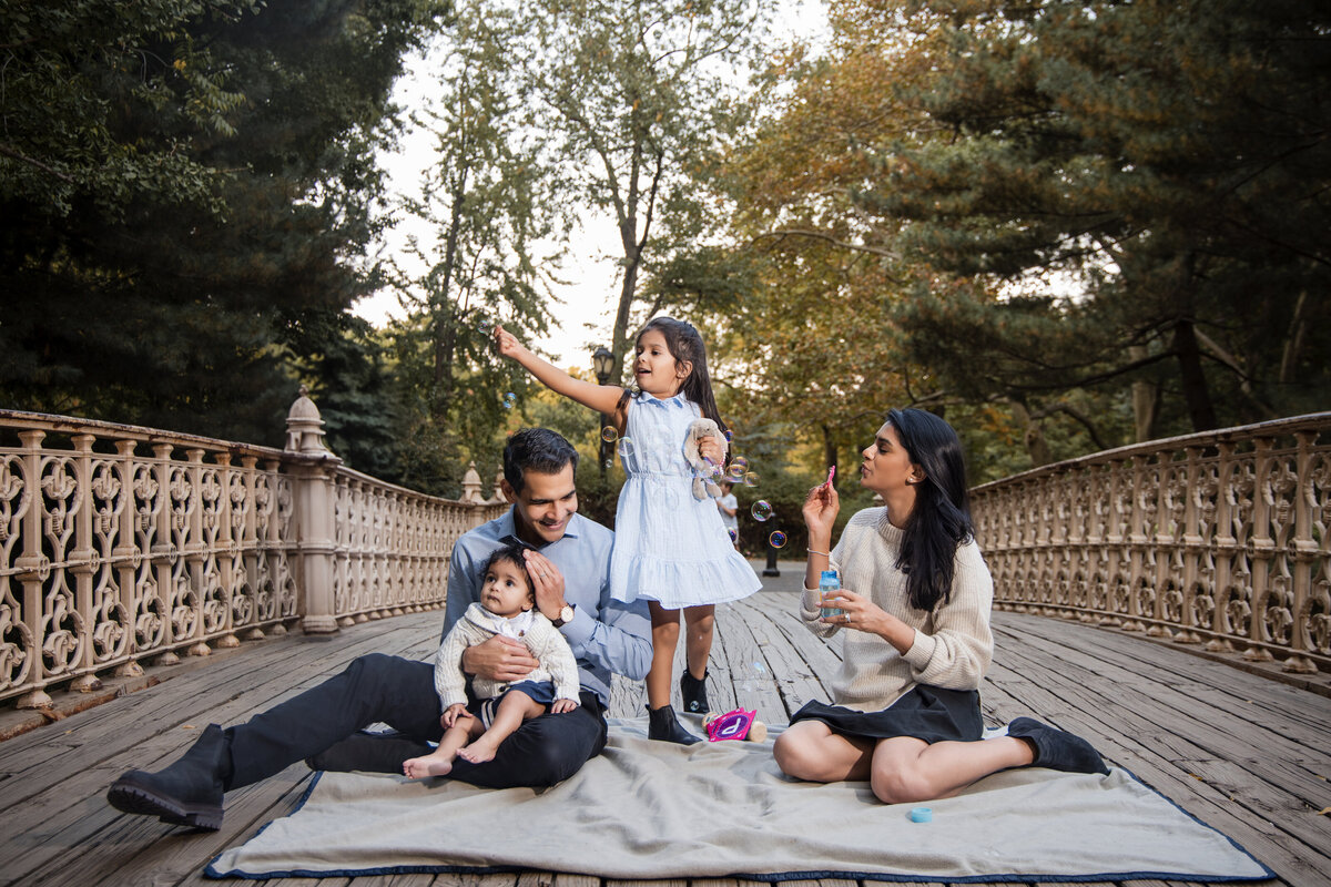 This photo was taken by a cinematic studio portrait photographer in NYC of a family in Central Park